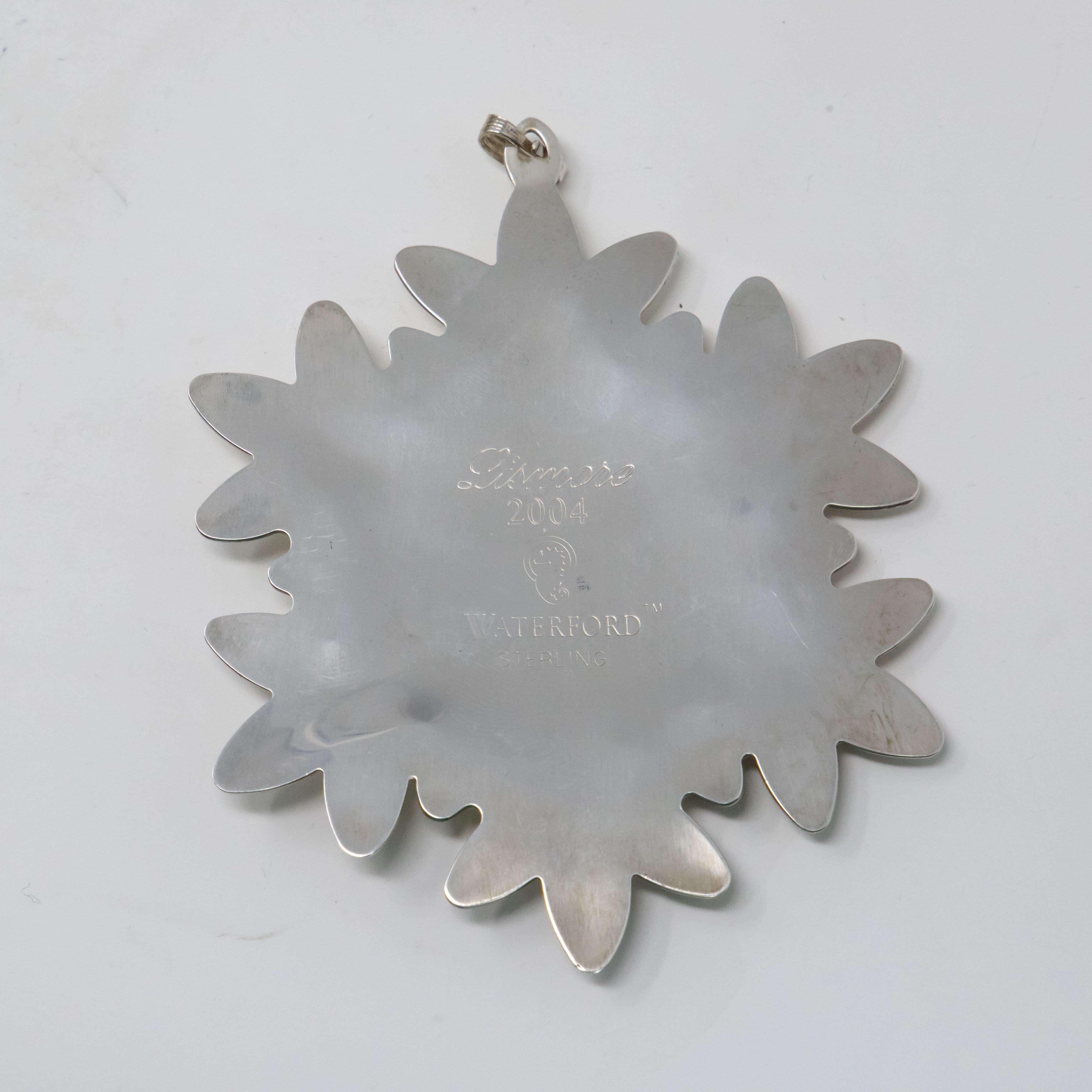 Offering this gorgeous sterling snowflake ornament by Waterford. This is the ornament from 2004. Starting in the middle with a point that goes outward is 6 points. Slowly opening towards the tips with raised rounded shapes in a geometric pattern.