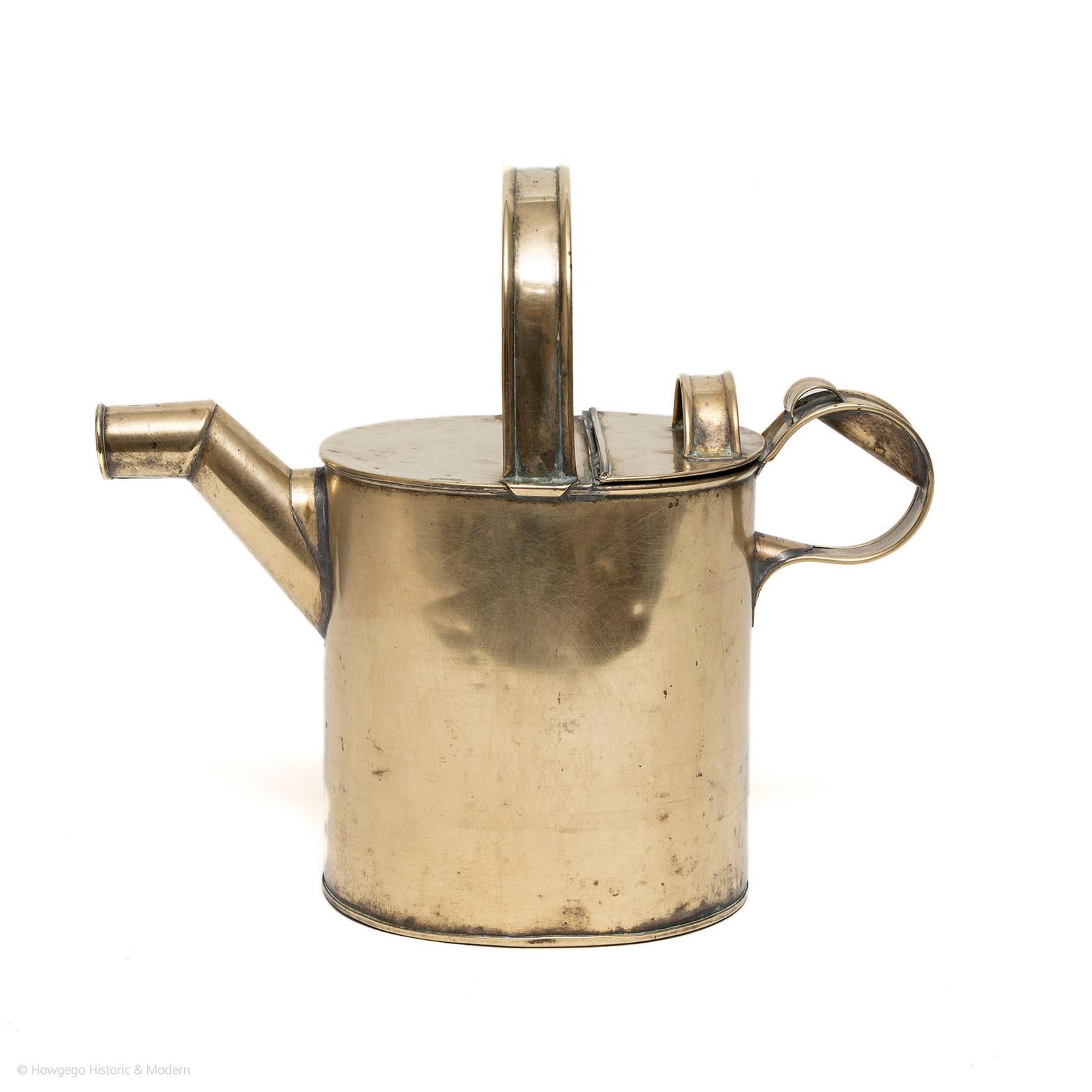Perfect size for house plants, seeds or carrying hot water.
Beautiful collectors item or decorative object.

A fine Victorian oval, brass watering can or hot water jug. Upper brass handle across top, back section of the top hinged to pour in