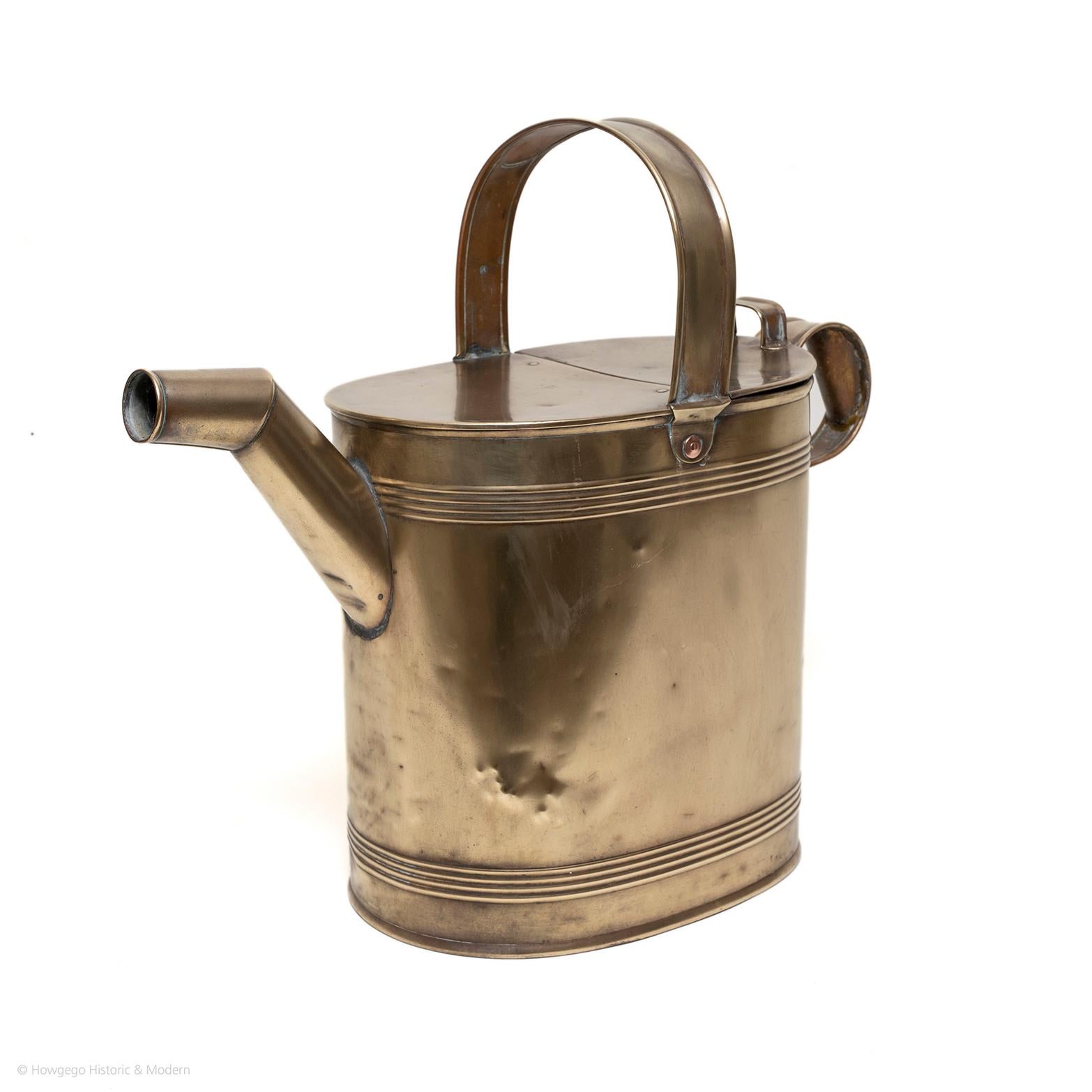 Beautiful collectors item or decorative object.
Suitable for regular use injecting a touch of history into gardening

A fine Victorian oval, brass watering can or hot water jug. Upper brass handle across top, back section of the top hinged to