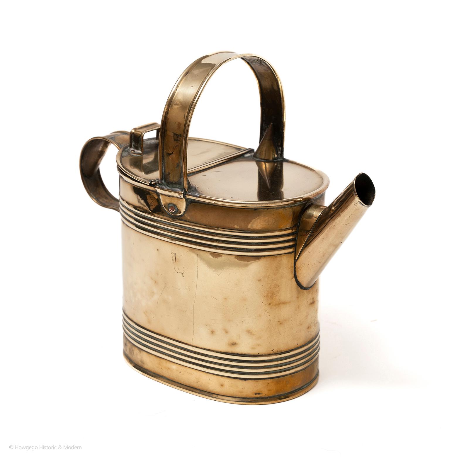 Perfect size for house plants, seeds or carrying hot water.
Beautiful collectors item or decorative object.

A fine Victorian oval, brass watering can or hot water jug. Upper brass handle across top, back section of the top hinged to pour in