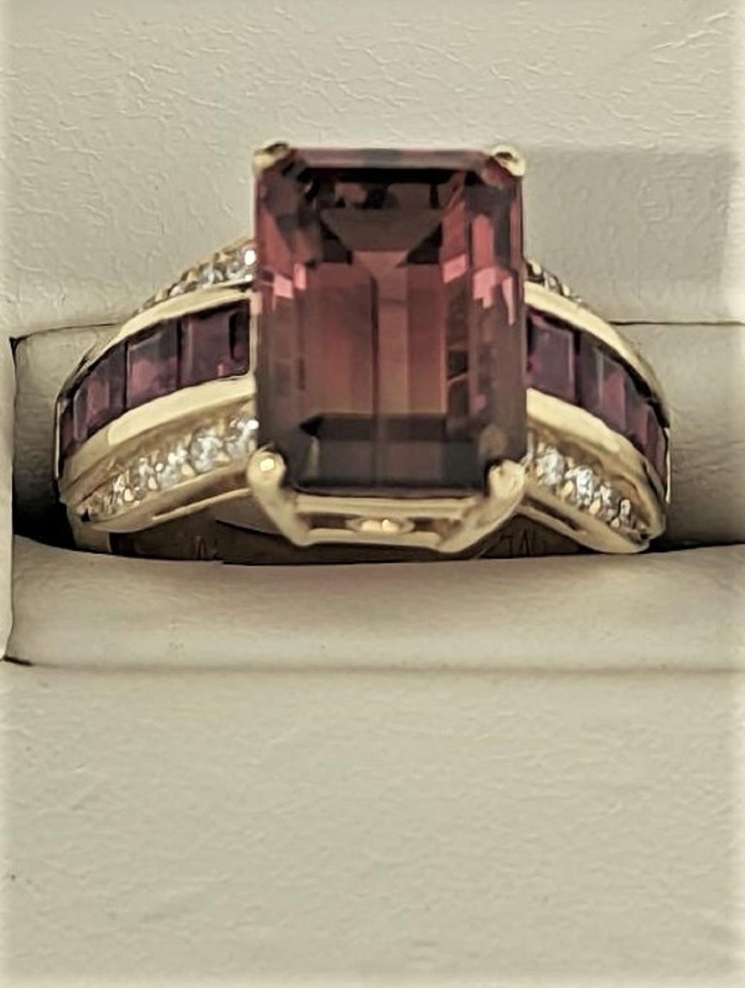 This Emerald Cut Watermellon Tourmaline or if you prefer, Tri color Tourmaline, is set in an 18K yellow gold mounting. The beauty of the stone lies in the transition of colors from darker red, to pink, a small white space and the darker green