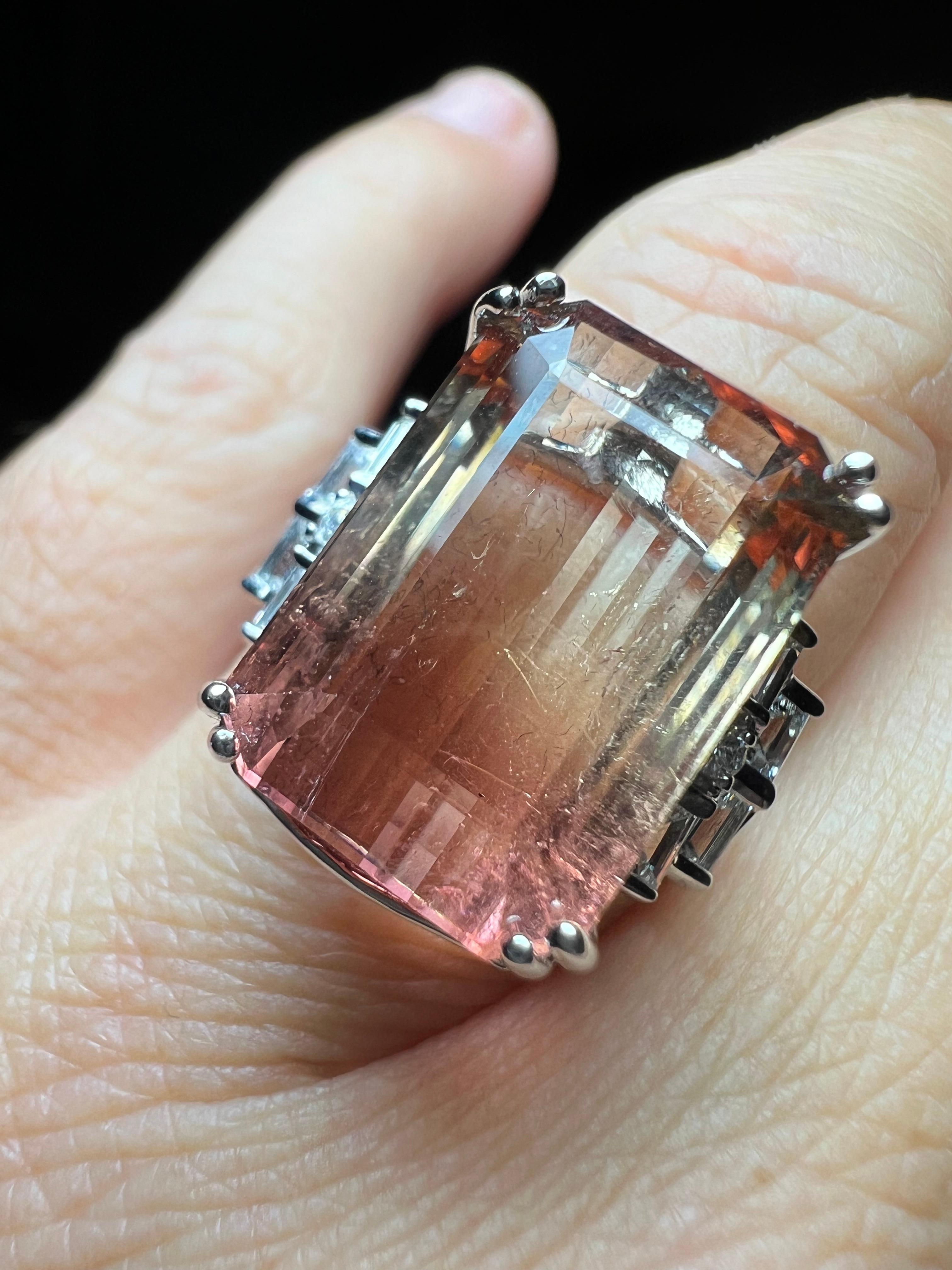 ring in 18 carat white gold set with a large tourmaline with a delicate gradient of color then called 