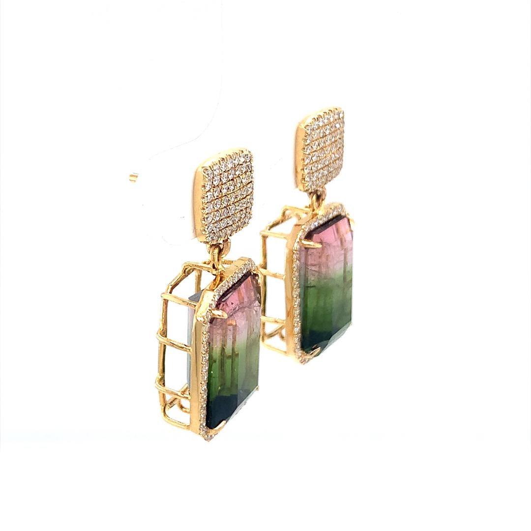 A stunning set of earrings consisting of a 8.40-carat natural watermelon Tourmaline and a natural 0.65-carat diamond all set in 18-Kt yellow gold. 