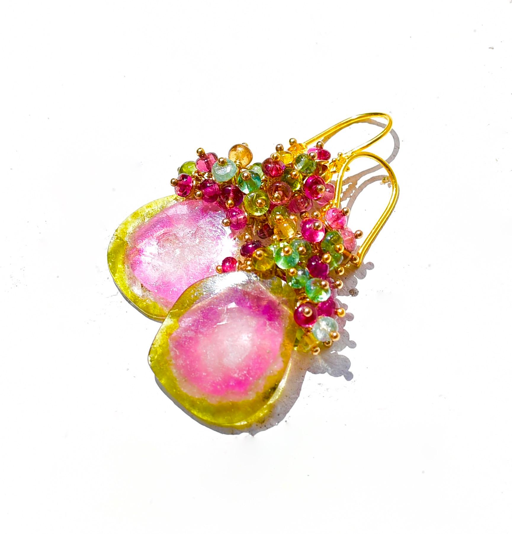 A gorgeous pair of watermelon tourmaline slice earrings with multi-colored tourmalines! One-of-a-kind slices have been accented by rubellite pink, green, blue, yellow tourmaline smooth beads. These earrings are suspended from 18K Yellow Gold ear