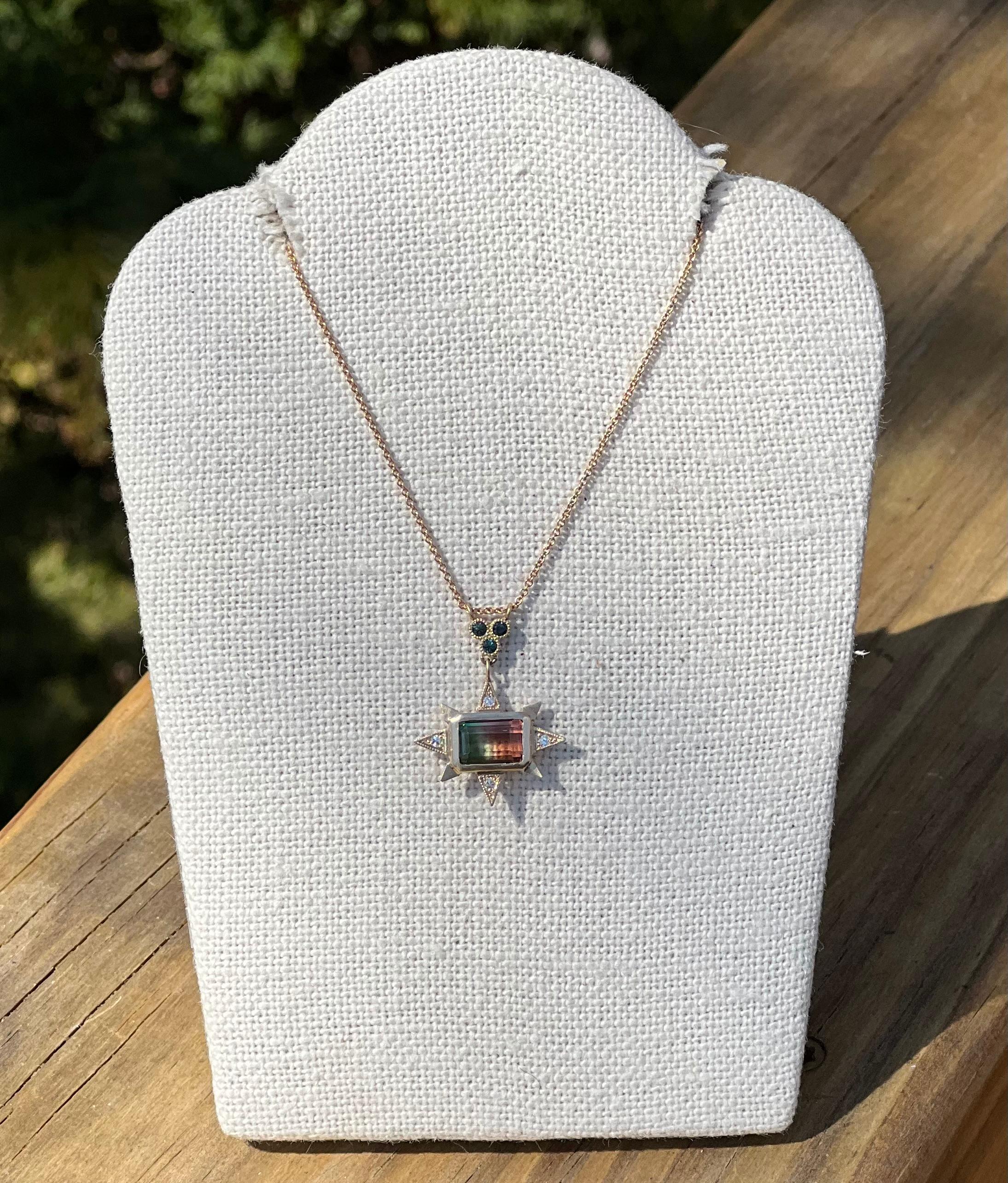 One handmade 14 karat yellow gold pendant with one 2.03 carat watermelon tourmaline set with east to west orientation in a celestial bezel set design with four single cut round diamonds, 0.04-carat total weight with matching H/I color and SI1/SI2
