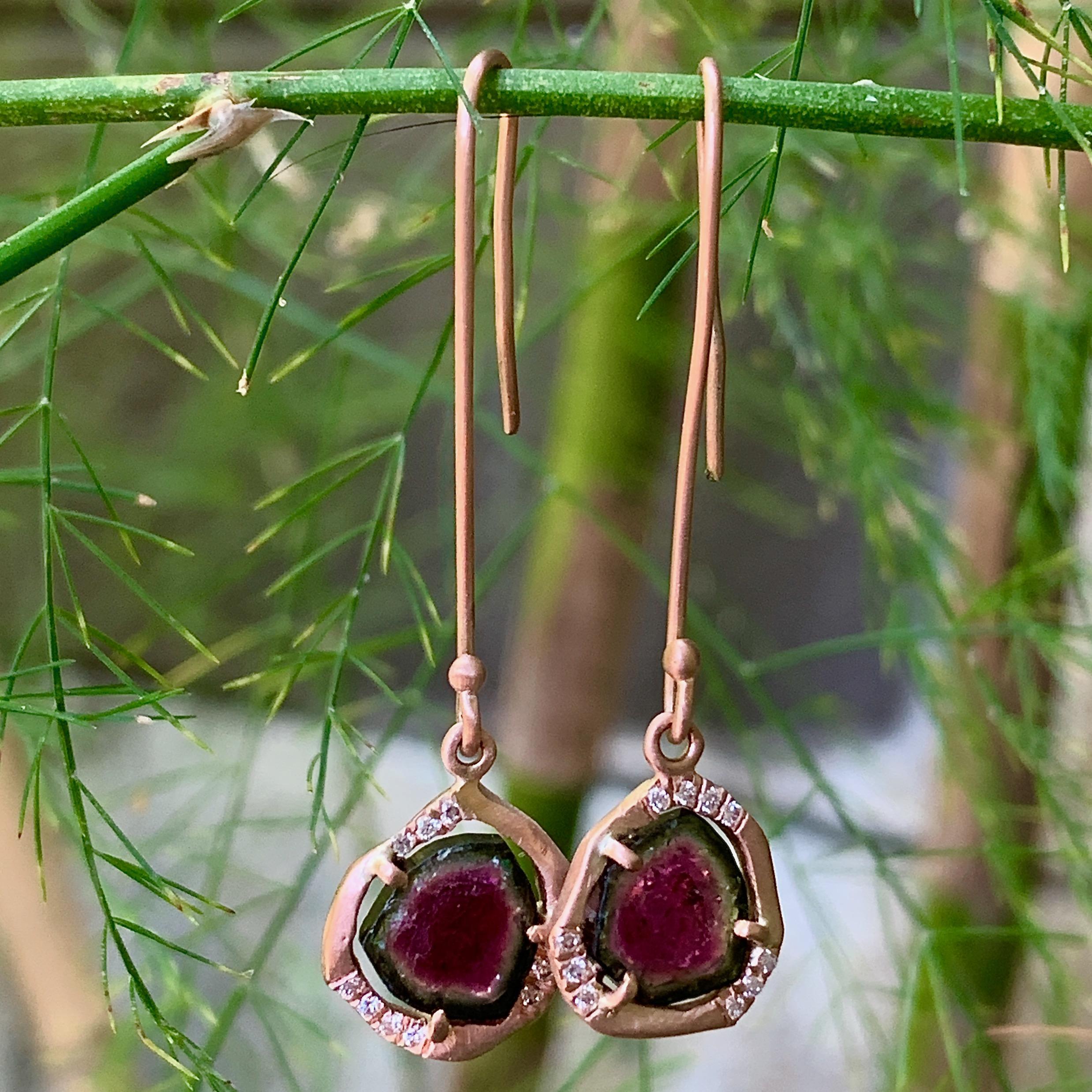 Eytan Brandes made these earrings to show off two intensely colored, freeform slices of natural watermelon tourmaline from the Himalaya Tourmaline Mine in San Diego County.

The frosty, hand-finished rose gold halos hold the tourmalines in place