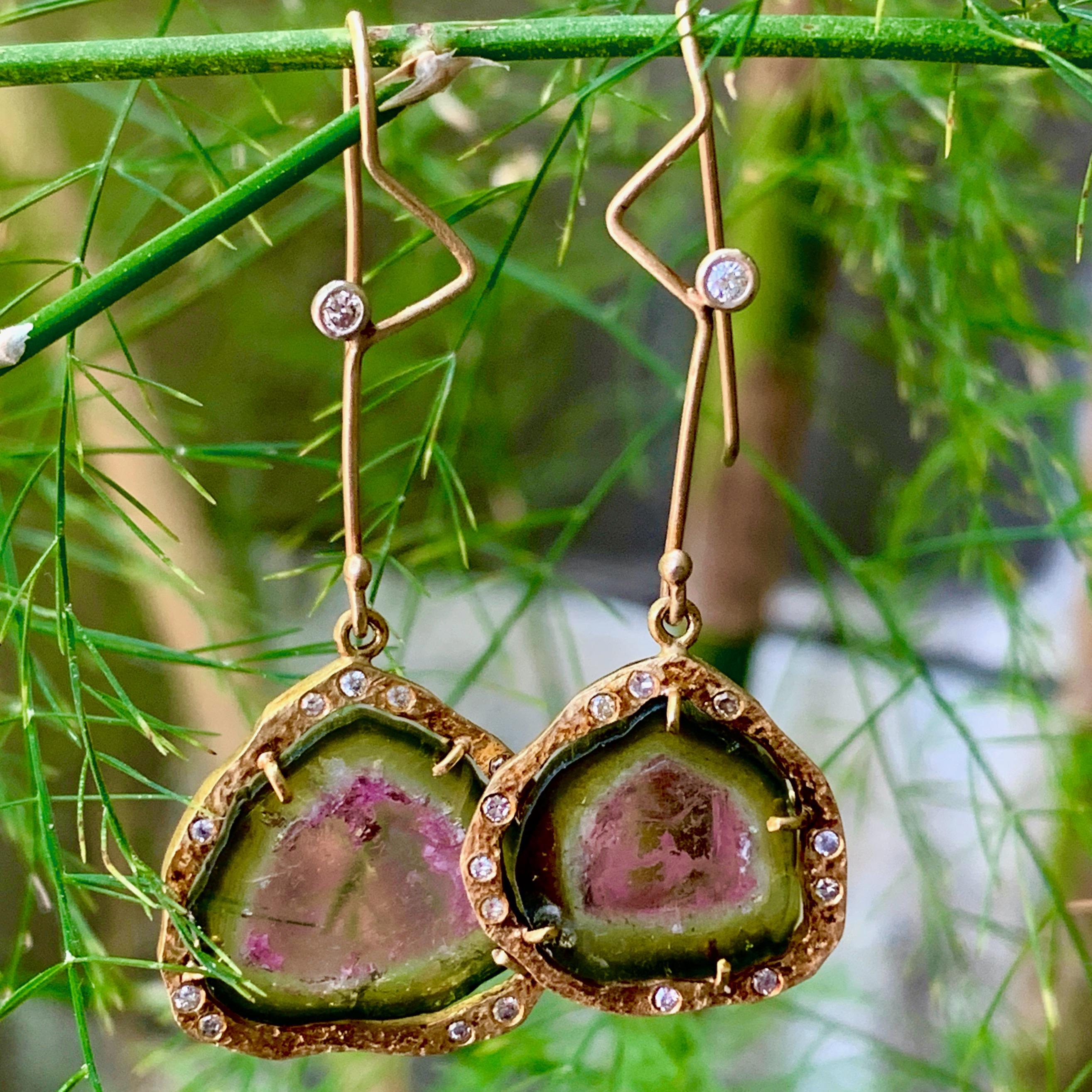 These freeform and playfully asymmetric earrings by Eytan Brandes feature slices of natural Brazilian watermelon tourmaline in halos of textured eighteen karat gold dotted with small, bright white diamonds.  Each hand-drawn wire closure is