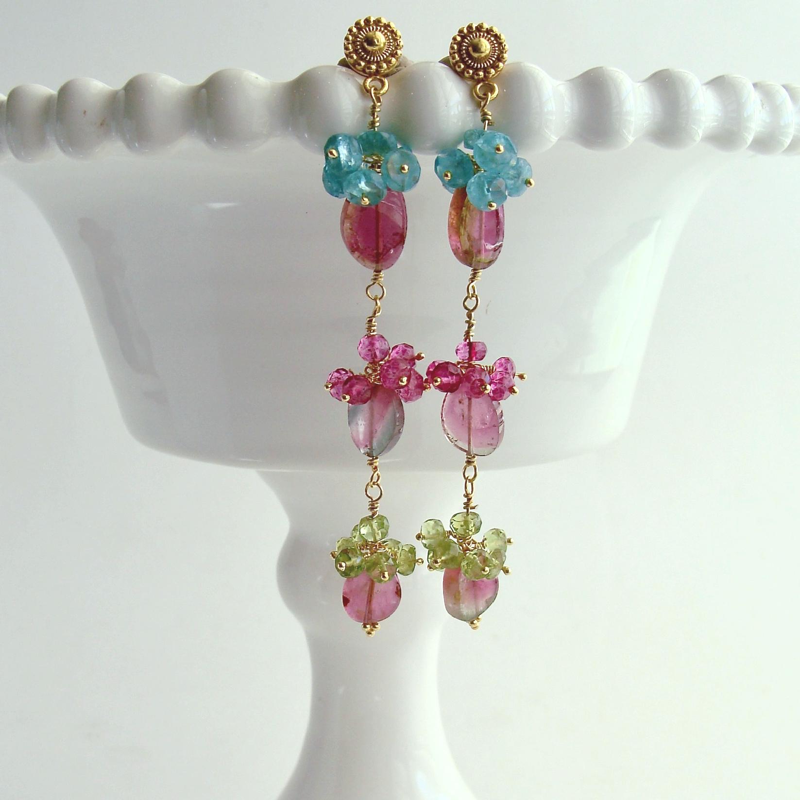 Andrea V Earrings.

A gorgeous pair of long and sinewy watermelon tourmaline slice earrings have been hand-linked and suspended from gold vermeil Byzantine style posts.  Each of these one-of-a-kind slices (19.5 tcw) has been accented by peridot,