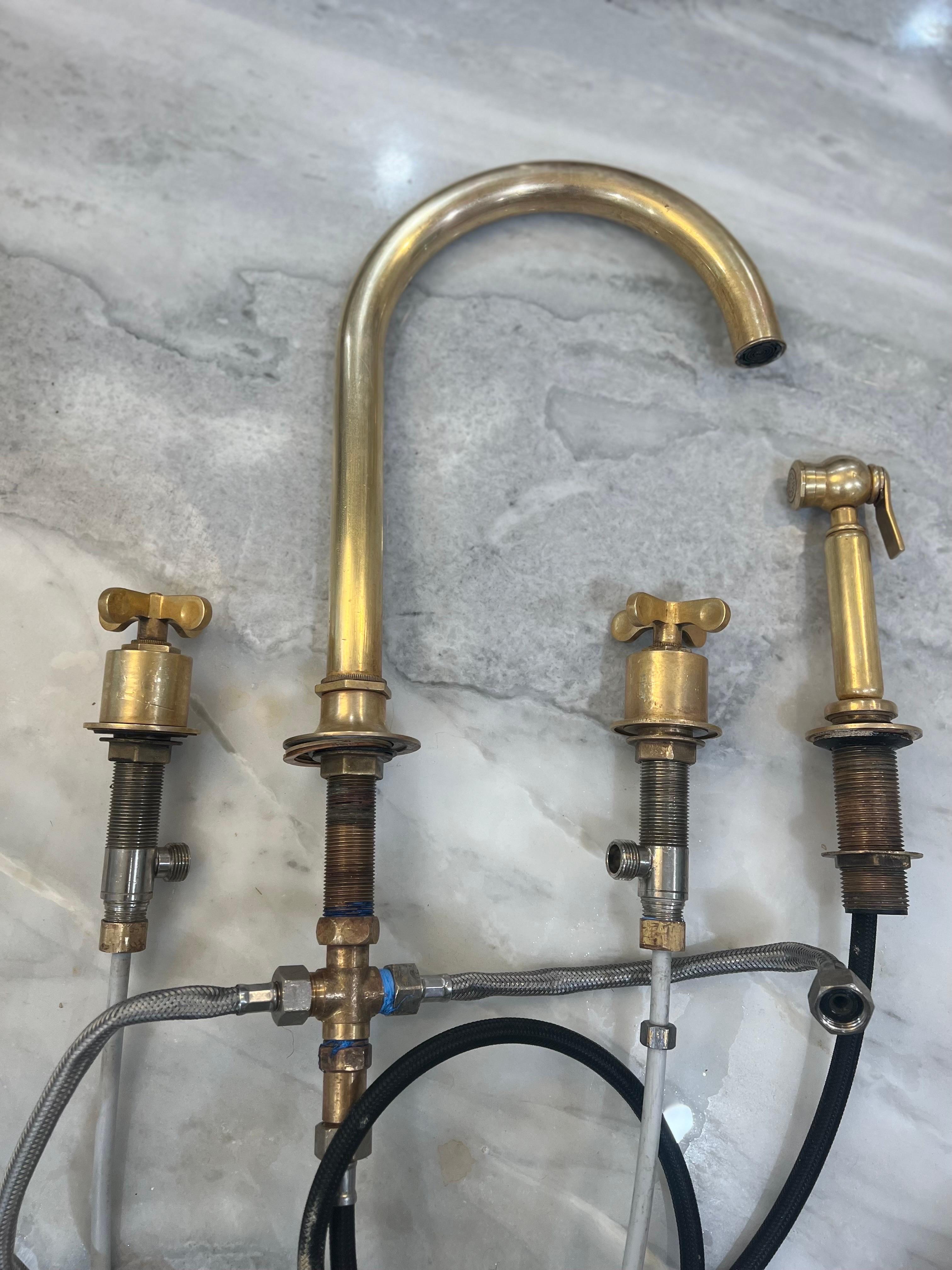 Ships immediately. No need to wait 35 week lead time for made to order from Waterworks. Get this one NOW! 

Three hole goose neck Waterworks Henry Faucet.  Includes sprayer.  
Influenced by the connection of industry and art Henry easily transitions
