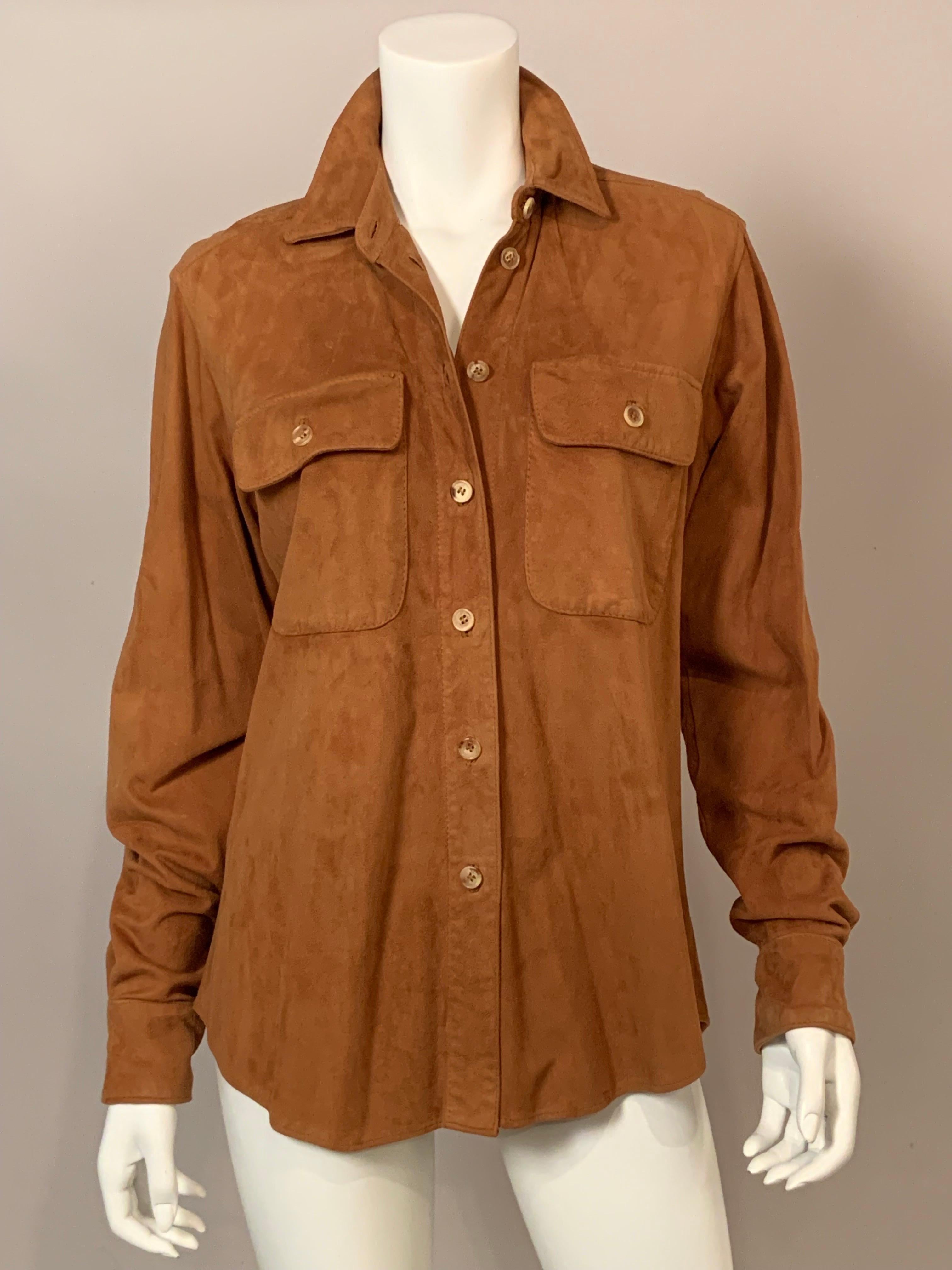 This is a classic shirt, but it is made with buttery soft caramel colored suede, and it was designed by the Wathne sisters from Iceland. There are two breast pockets and logo buttons at the center front and on the cuffs. A shirttail hem allows you