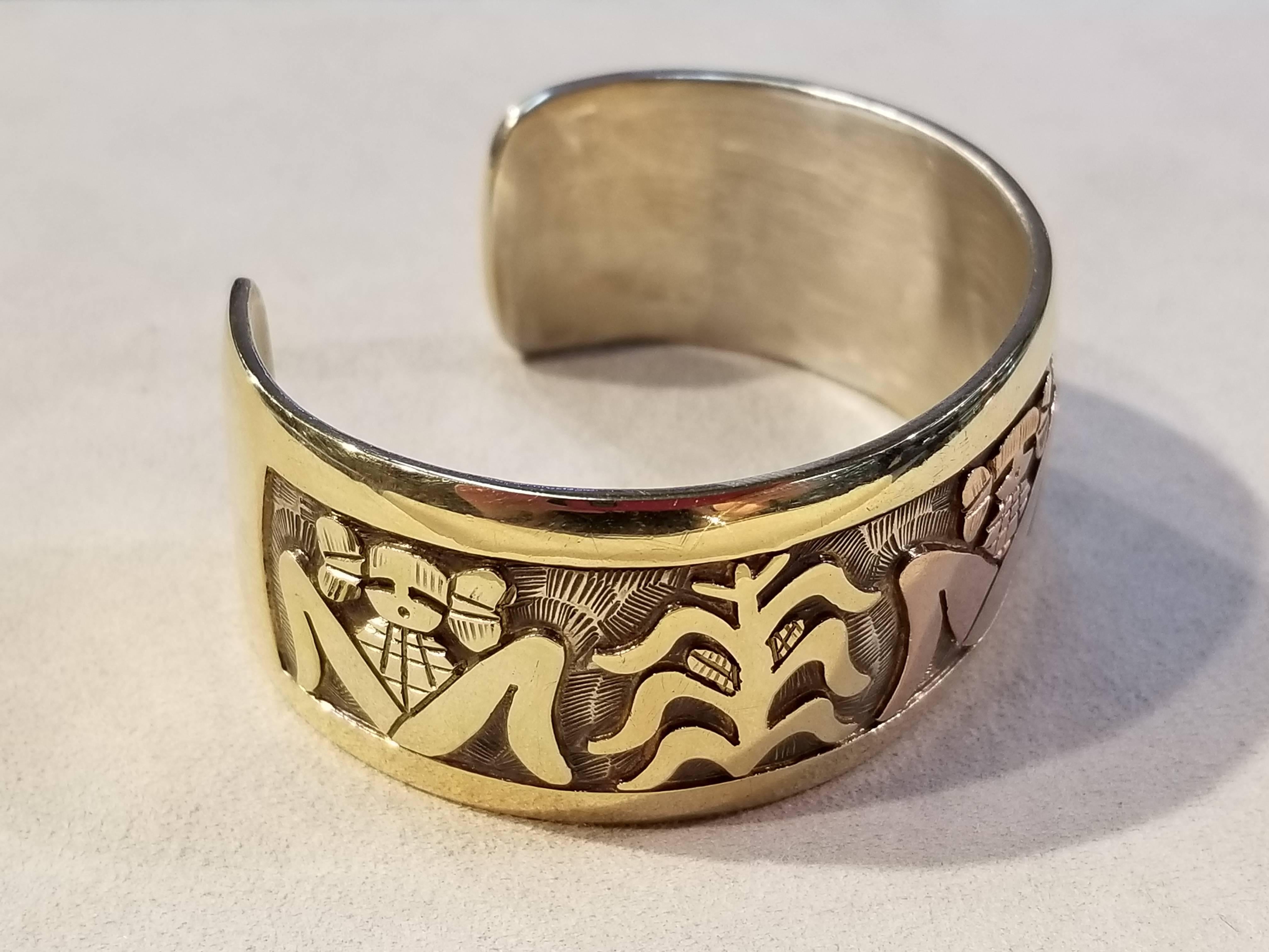 Watson Honanie, 14kt y/g & Sterling Hopi Corn Maiden Cuff.

Dimensions: Across; 2 1/4