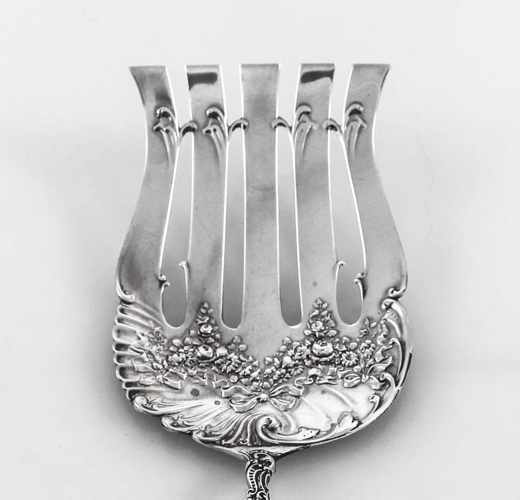 Proudly offering the fabulous sterling silver asparagus server by William Durgin Company. The pattern is Watteau and it was manufactured in 1891. It has a lovely floral pattern along the handle and on the server. A great piece to add to your