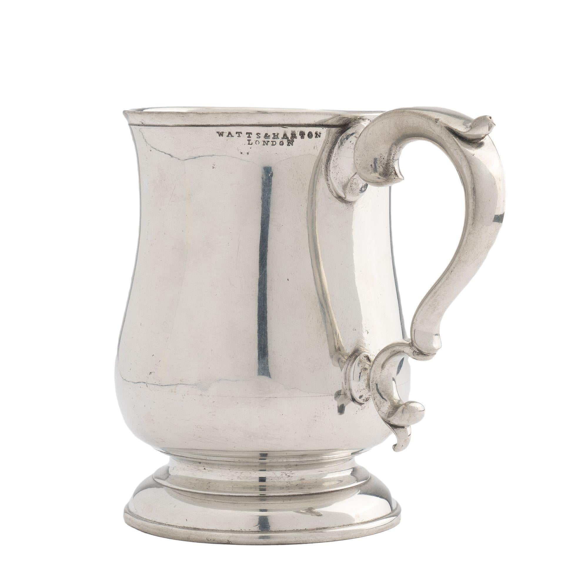 Tulip shaped polished pewter mug with applied scroll handle. Impressed on the rim: Pint, Watts & Harton, London

England, circa 1830.

Condition: Superficial surface crazing emanating from the applied handle attachments, horizontally from 1/2