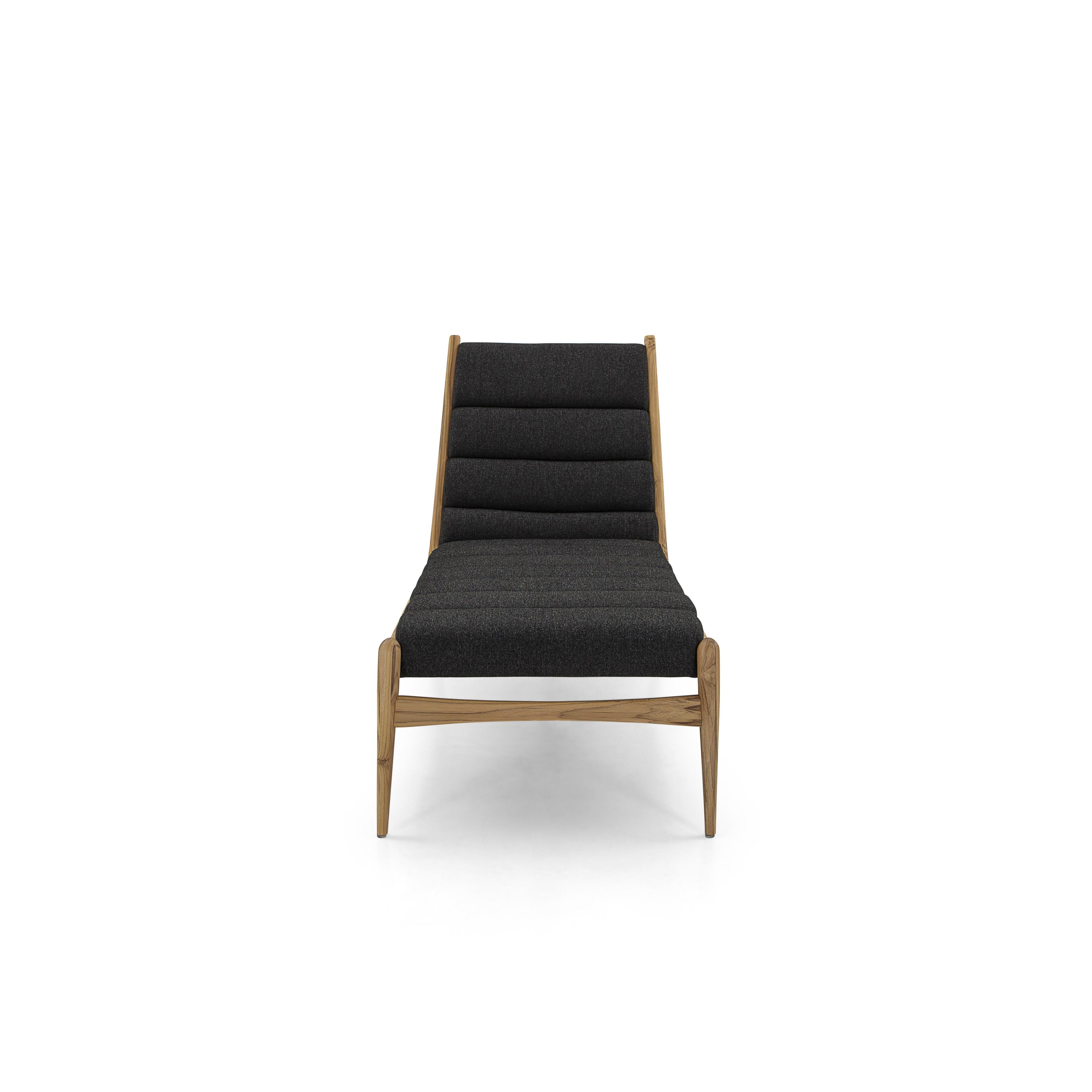 The Wave indoor chaise lounge in a teak wood Uultis finish, and its upholstery are reminiscent of waves in black fabric, which is the perfect addition for any contemporary, minimalist, or traditional design project. This chaise is the ideal chair to