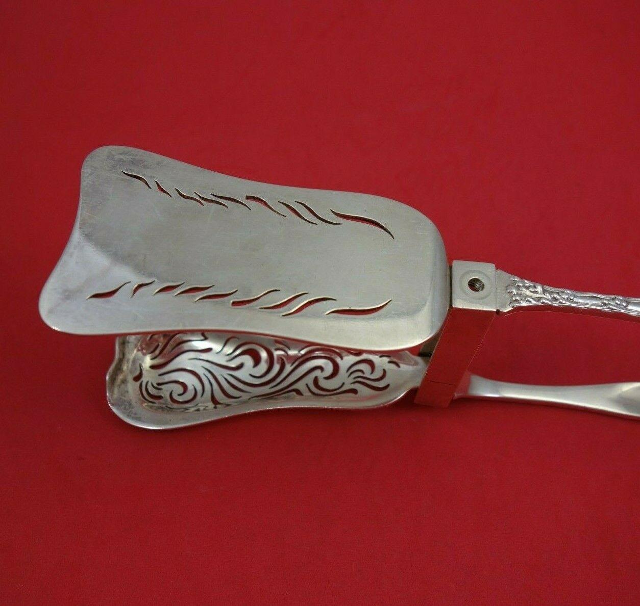 Wave Edge by Tiffany and Co

Sterling silver Asparagus Serving Tong Large English Style Yoked and Hand Pierced (rare form!) 10 3/8