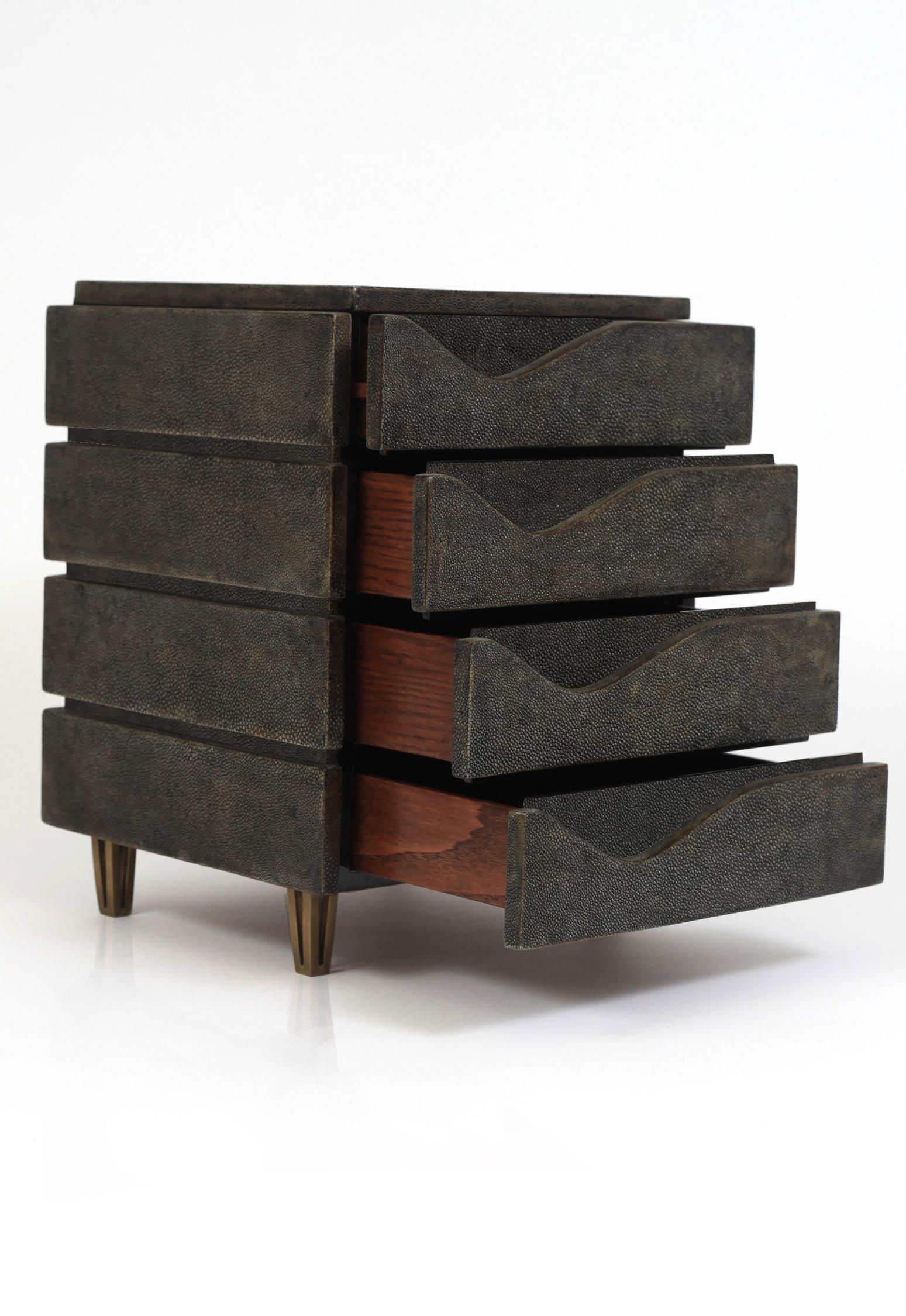 The Wave jewelry chest in coal black shagreen by R&Y Augousti is a stunning geometric piece to store your personal items. This piece has 4 drawer compartments and sits on 4 bronze-patina brass legs. See images at end of slide of other jewelry chests