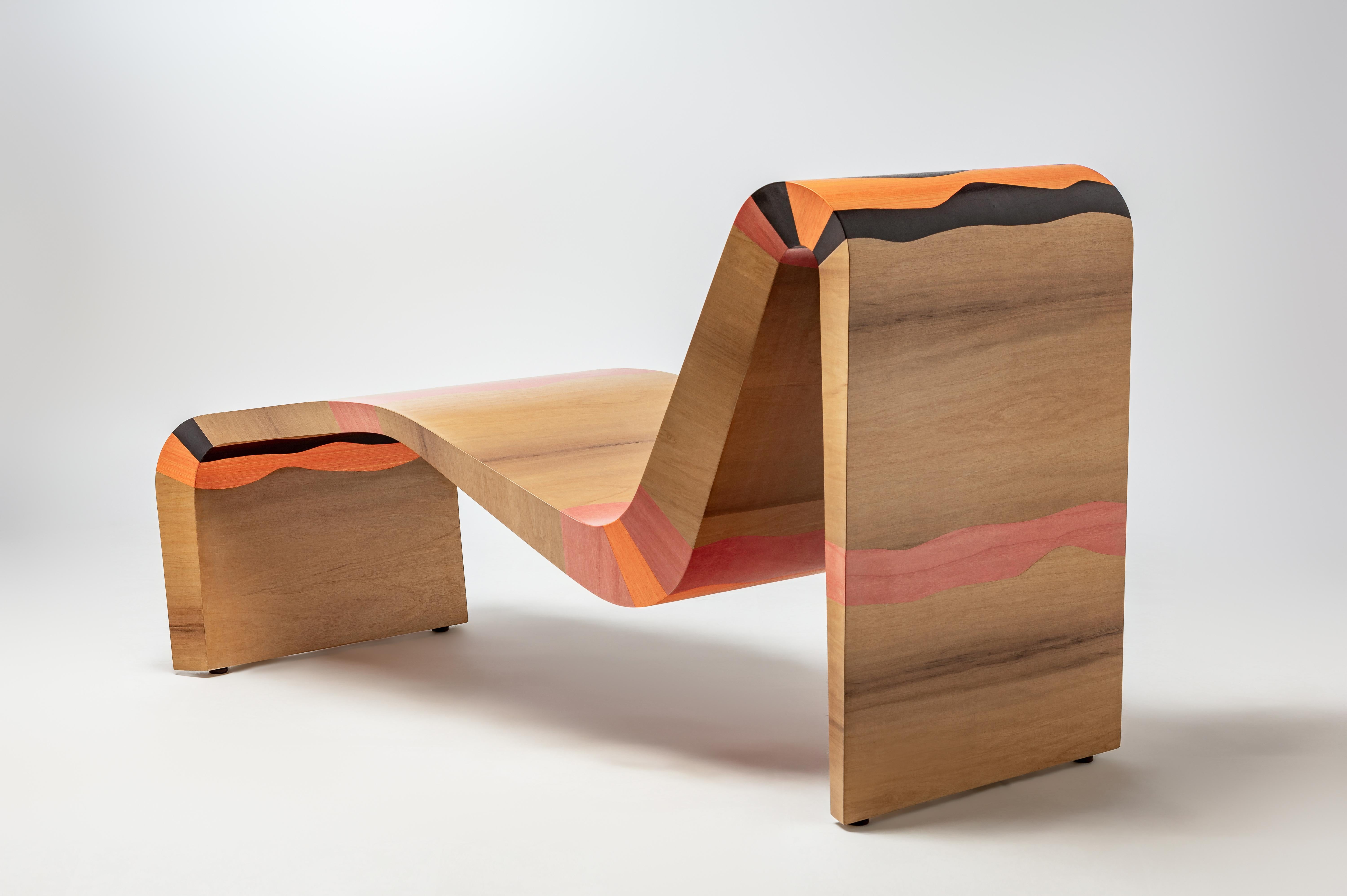 Wave Lounge Chair, a design extension of our iconic Wave Bench, is inspired by water and the state of flow.

It is produced with new materials, namely a fusion of colored marquetry wood veneer, capturing movement and elegance.

Artisanal