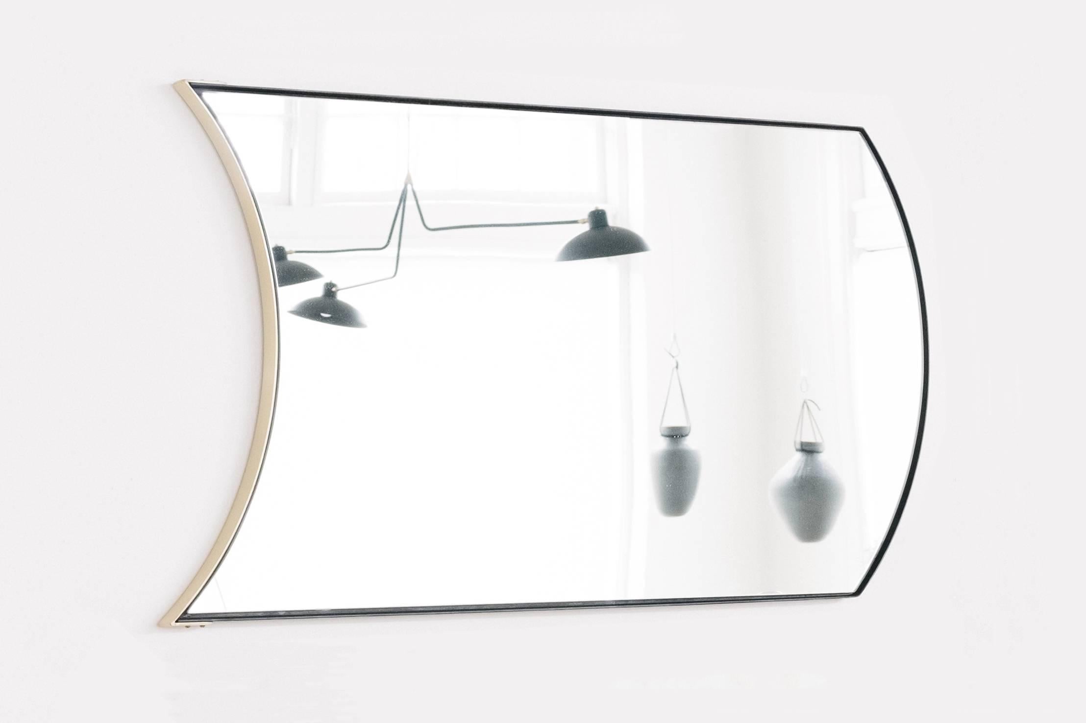 The Wave mirror is a minimal, contemporary design which brings simplicity, movement and depth to the home. A walnut back hides behind a two part frame consisting of half blackened steel and brass plated sections highlighted by brass fastener