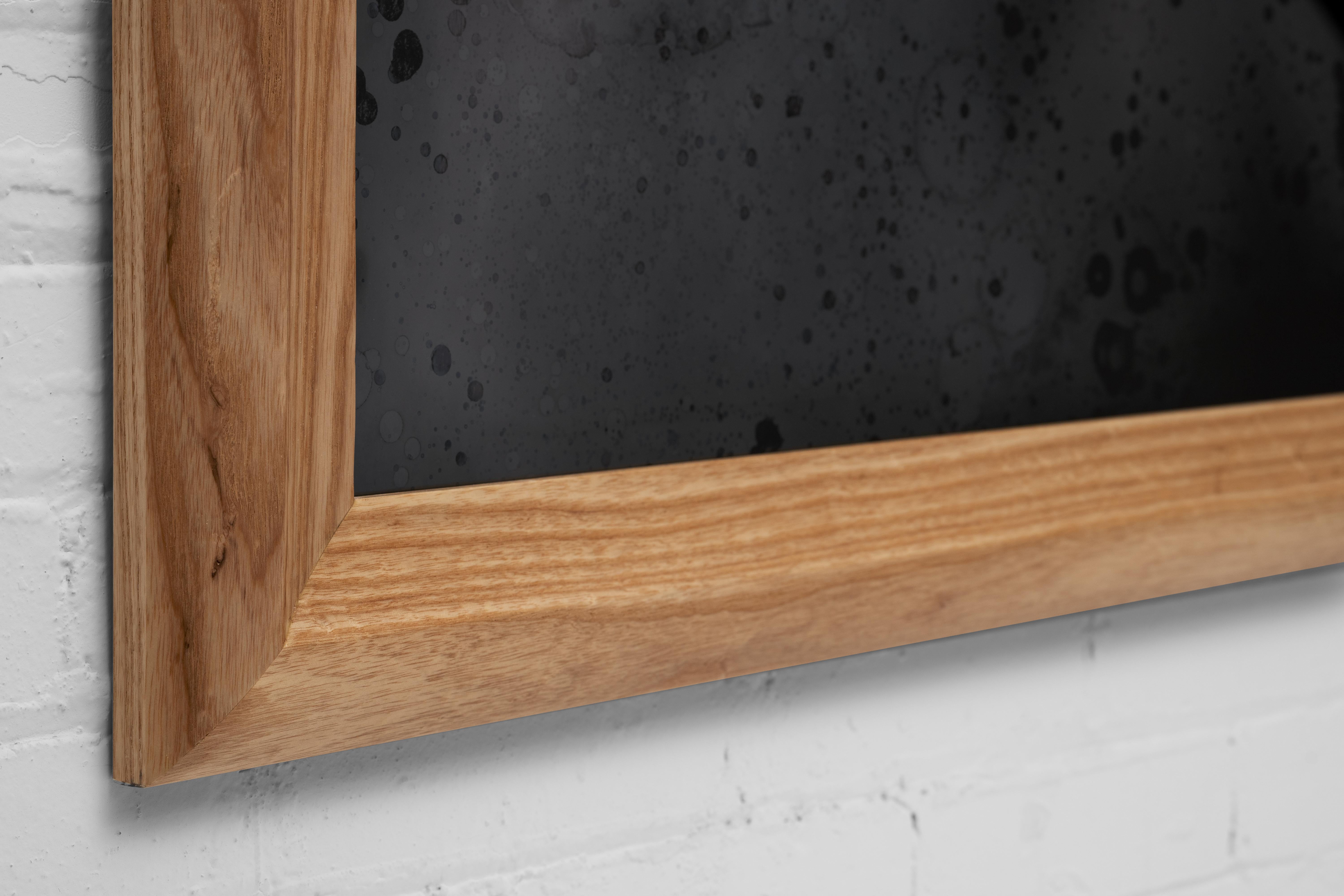 Soft rolling shapes on this solid wood frame draw the eye into a Scathain mirror.

All of our mirrors are custom-made to order and one of a kind. Our unique mirroring process produces wildly fantastic mirrors, rich with character and depth. This