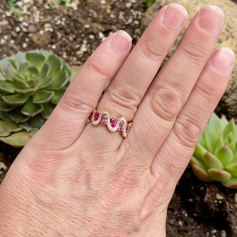 Cresting waves curve across your finger amid vibrant pink sapphires and rich red rubies. Set in rich 14K yellow gold, this ring blends playful color with classic elegance.

Also available in orange sapphire and green sapphire... message us for