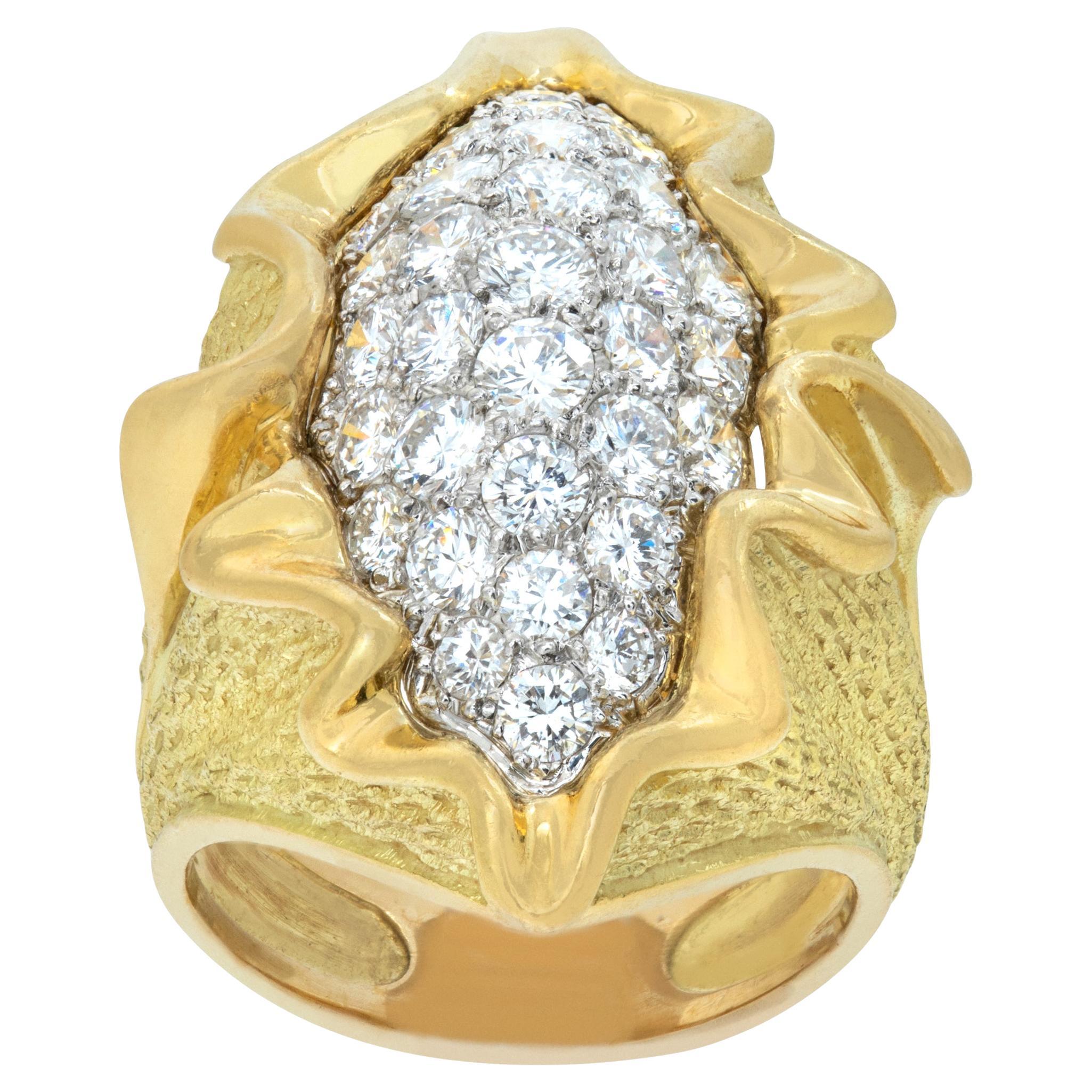 Wave ring with round brilliant cut diamonds set in yellow and white gold. For Sale