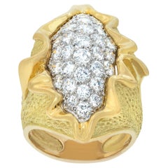 Wave ring with round brilliant cut diamonds set in yellow and white gold.
