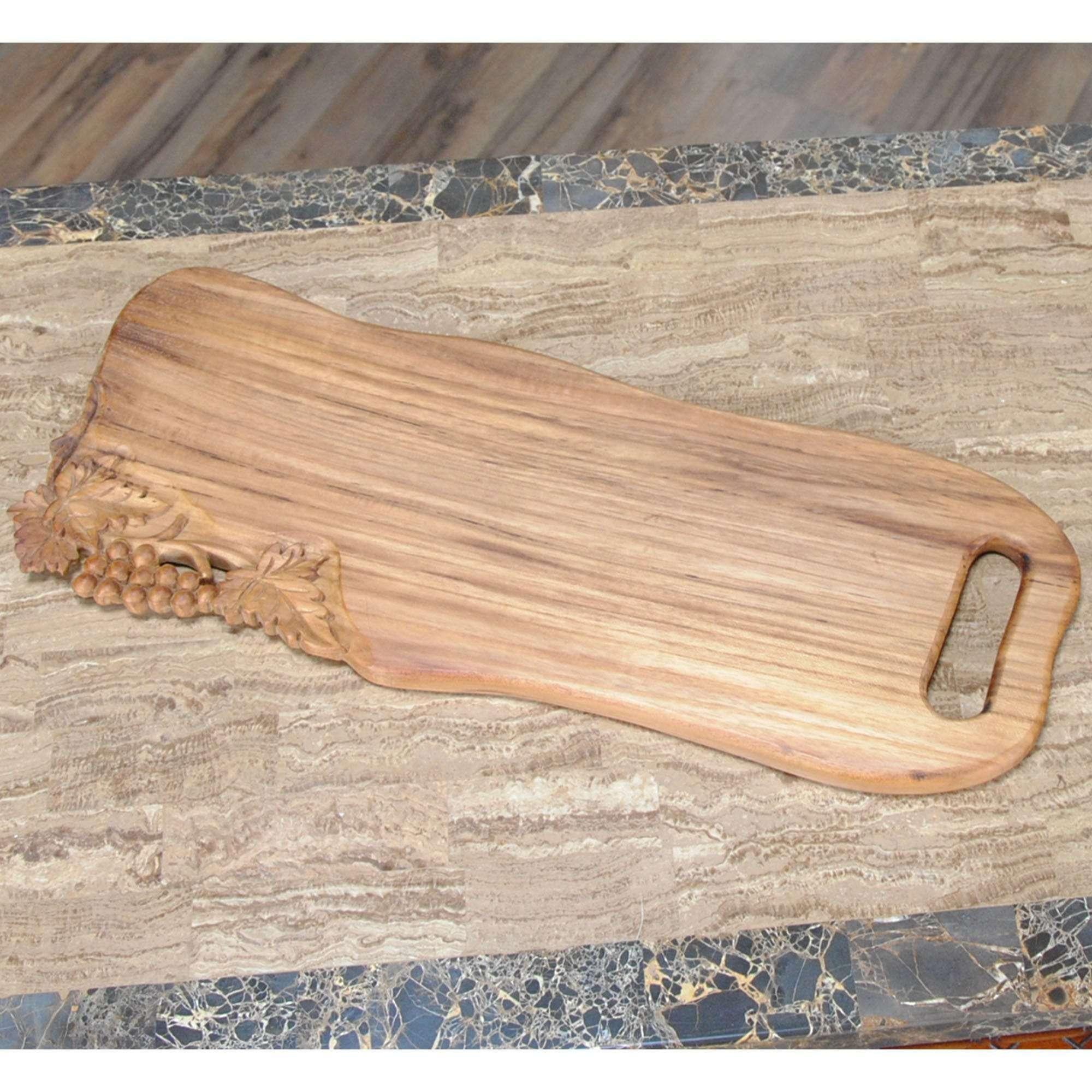Hand-Carved Wave Shaped Teak Cutting Board with Grapes For Sale