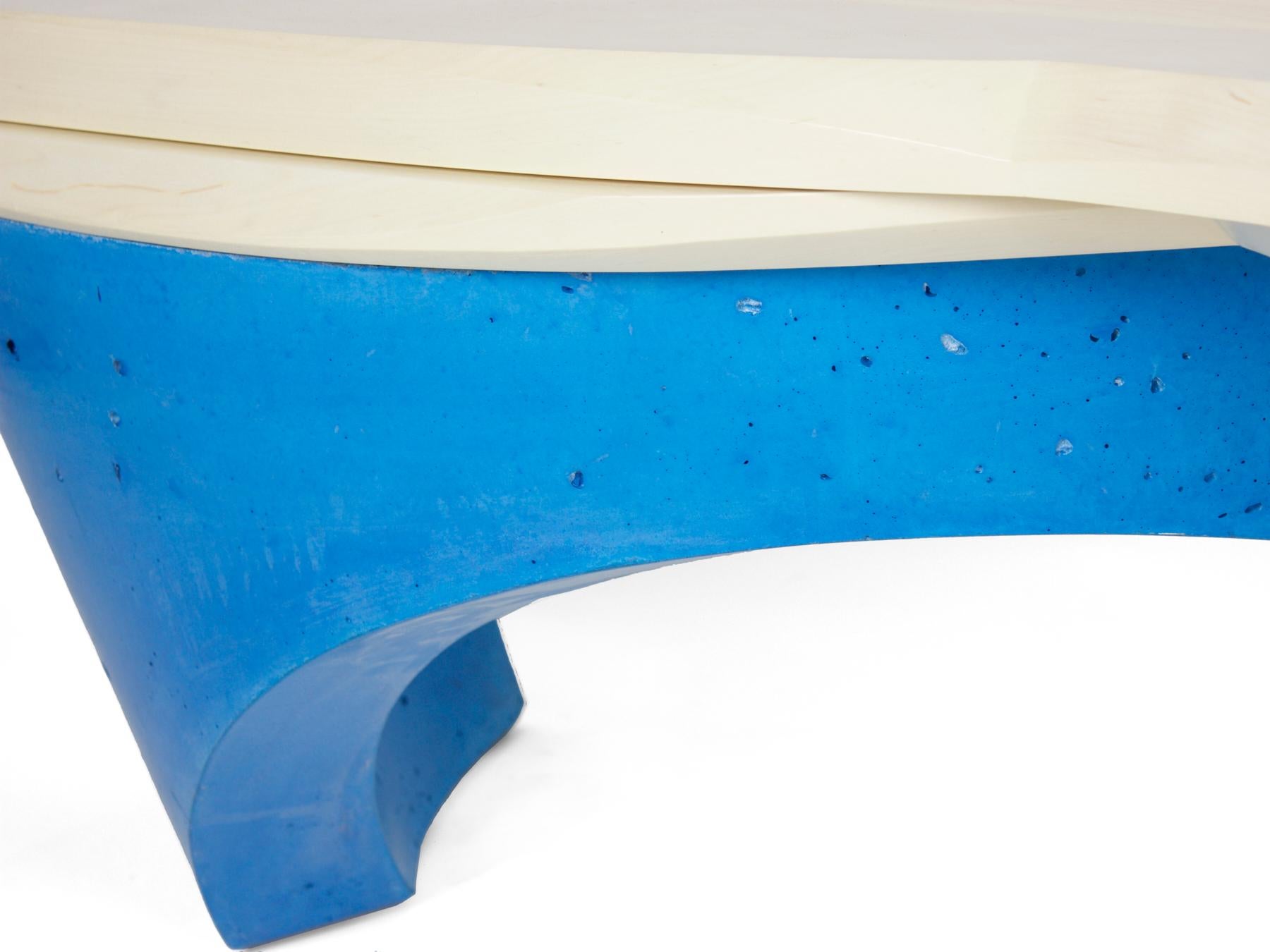The waves bench is comprised of two curved concrete legs which establish the dynamic movement of the piece. The blue cast concrete legs are pigmented which results in a color that goes all the way through the concrete. The bleached maple seat is
