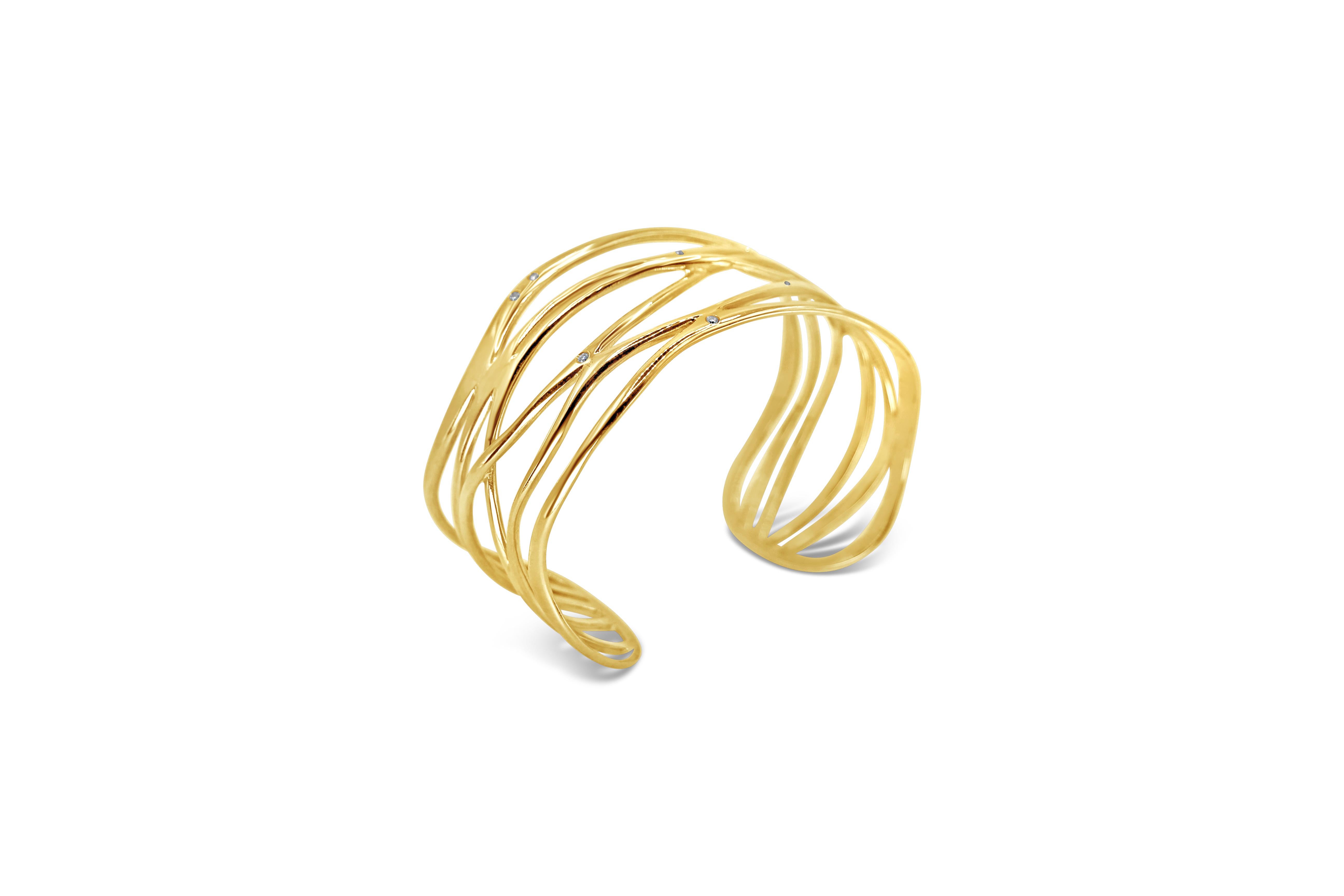 Sea Waves Cage Cuff Bracelet with white brilliant cut diamonds handcrafted in 18Kt solid yellow gold.
Elegant stripes of 18Kt gold create this delicate shape in the bracelet giving the sense of a smooth wave around your wrist. The white brilliant