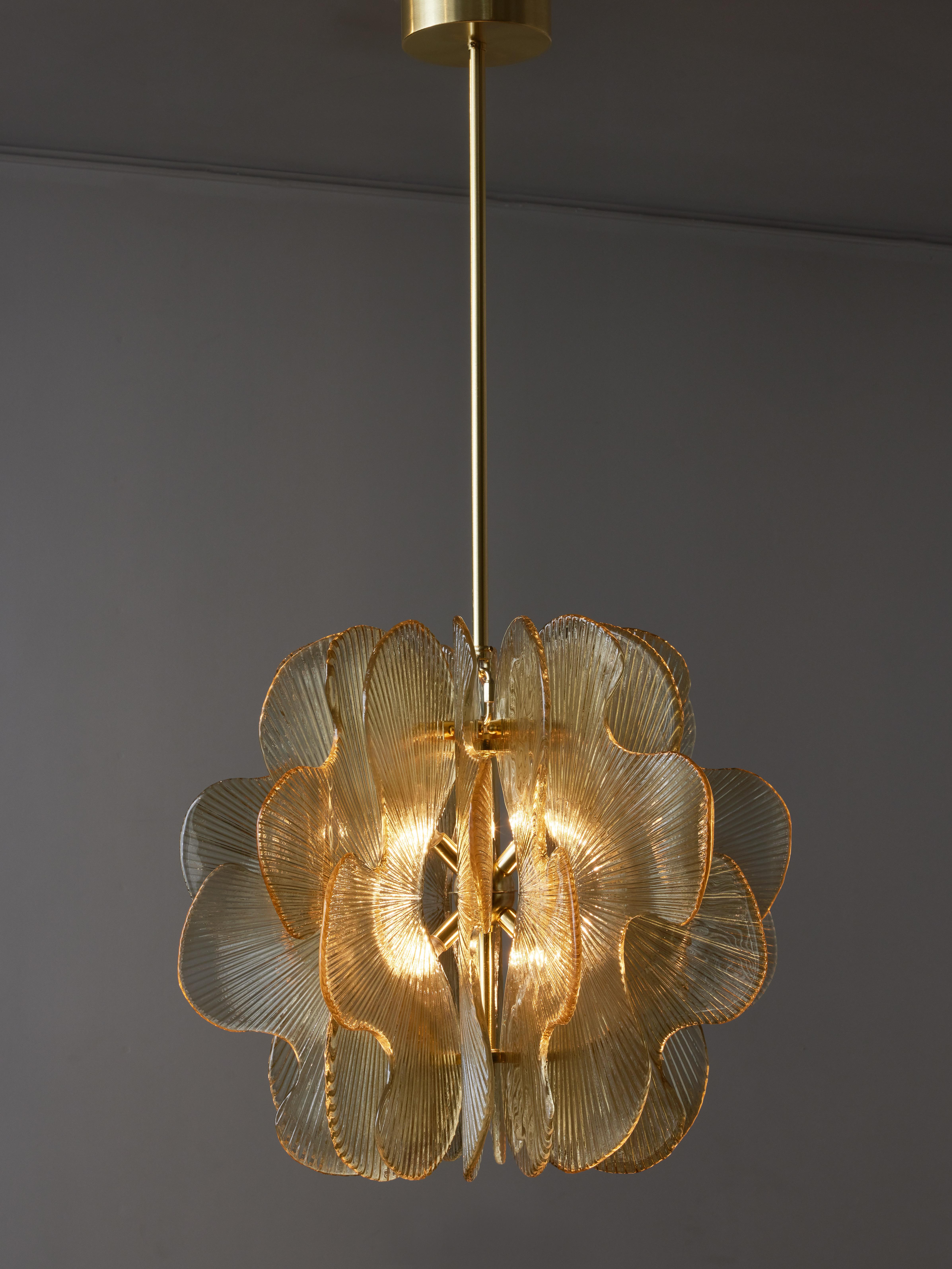 Brass suspensions on which are placed different shaped Murano glass slabs streaked and tinted.