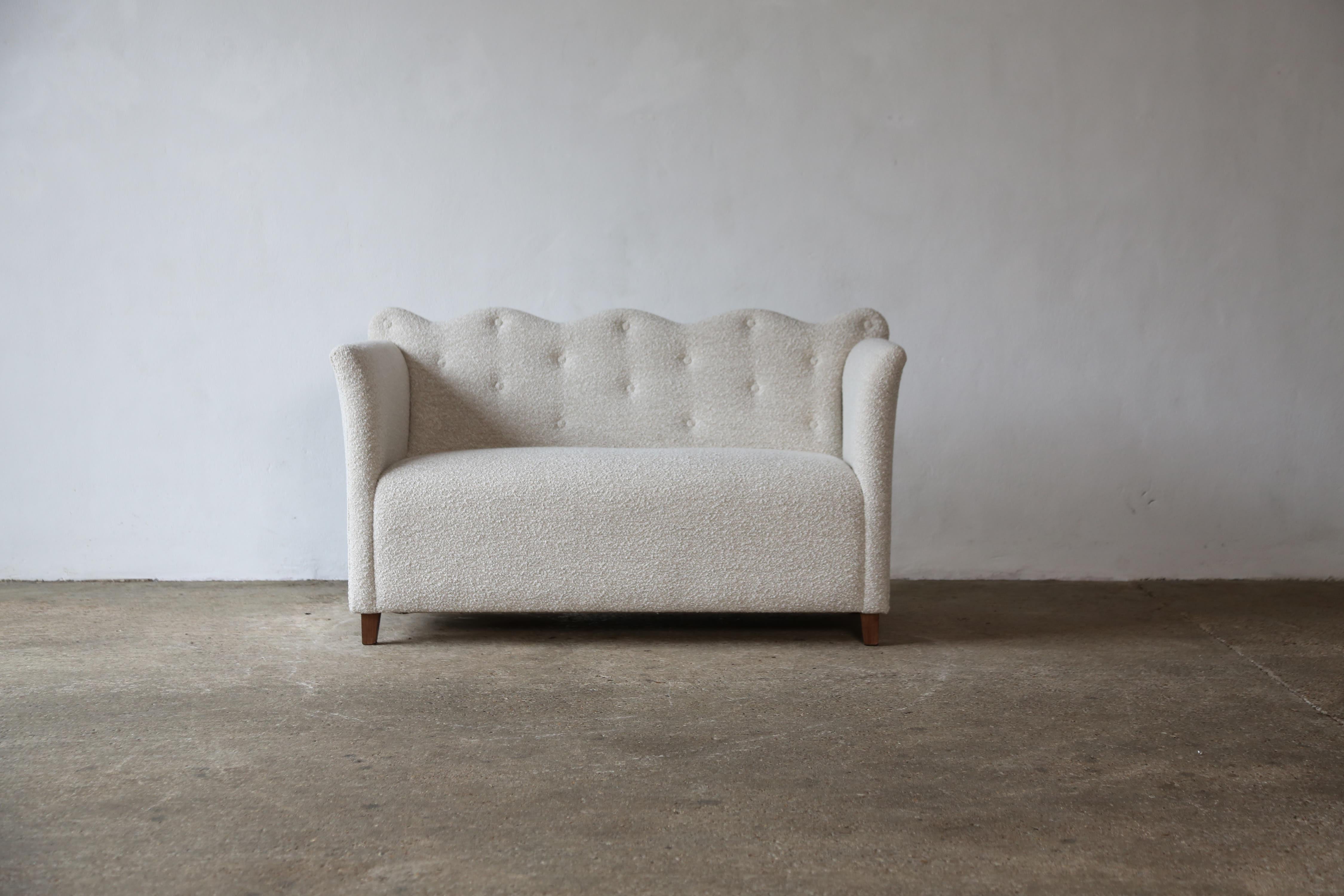An elegant modern scallop back sofa upholstered in Lelievre Lama Naturel wool boucle.  Fast shipping worldwide.
