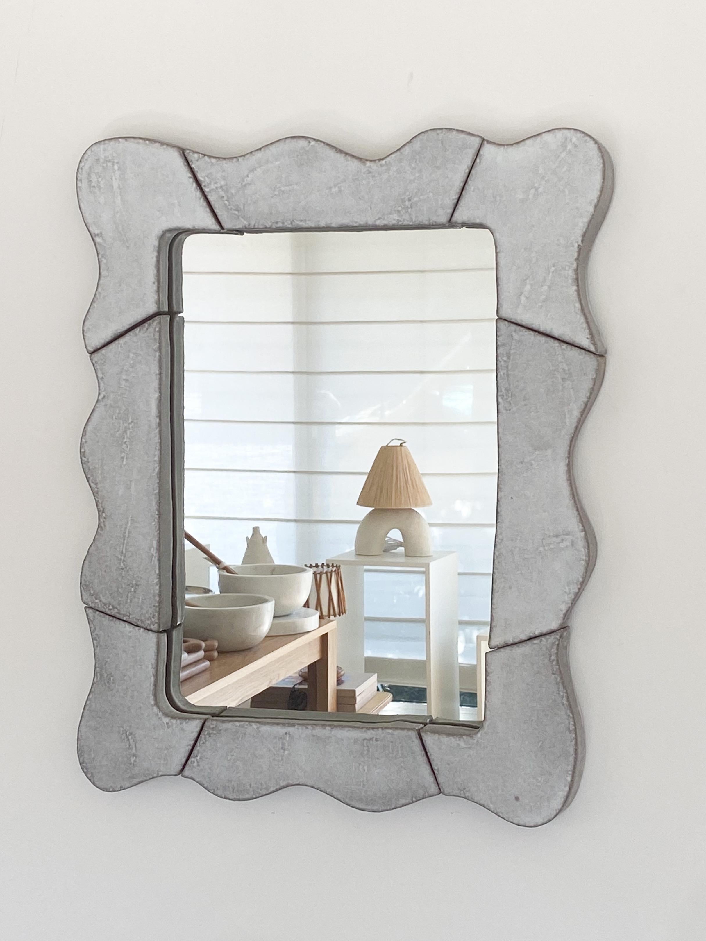 Newly made wavy ceramic mirror. Hand-sculpted sections of ceramic placed together to create a beautiful wavy rectangular frame. White glaze over terracotta creates beautiful white-grey coloring.