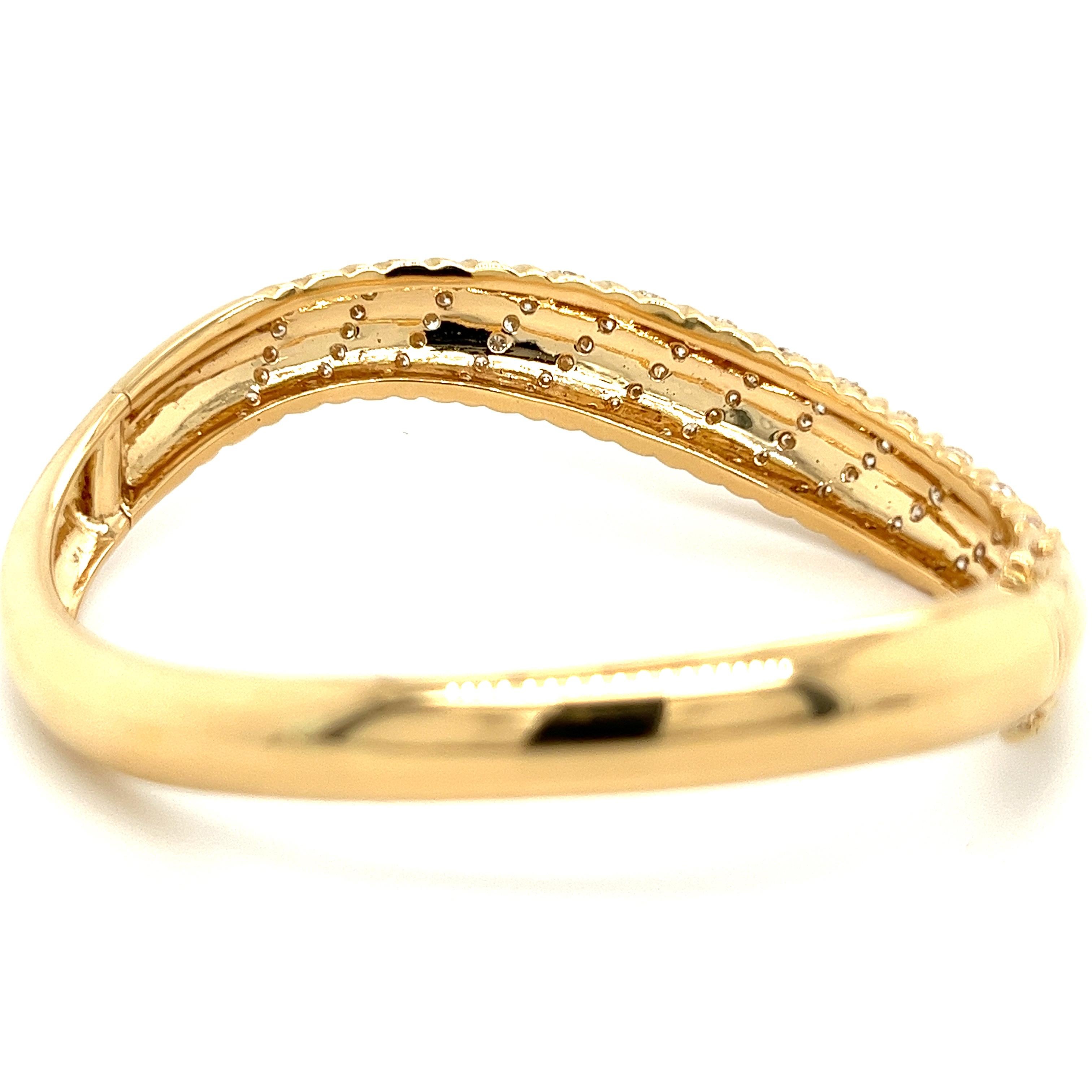 18 karat yellow gold bangle with 2.50 carats in round cut diamonds. Handmade with a wavy motif and textured gold. 

Details: 
✔ Metal: 18K 
✔ Diamond Carat: 2.50 (approx.)
✔ Diamond Quality: Excellent cut, E-F color, VS1-VS2 clarity 
✔ Size: 11.3mm
