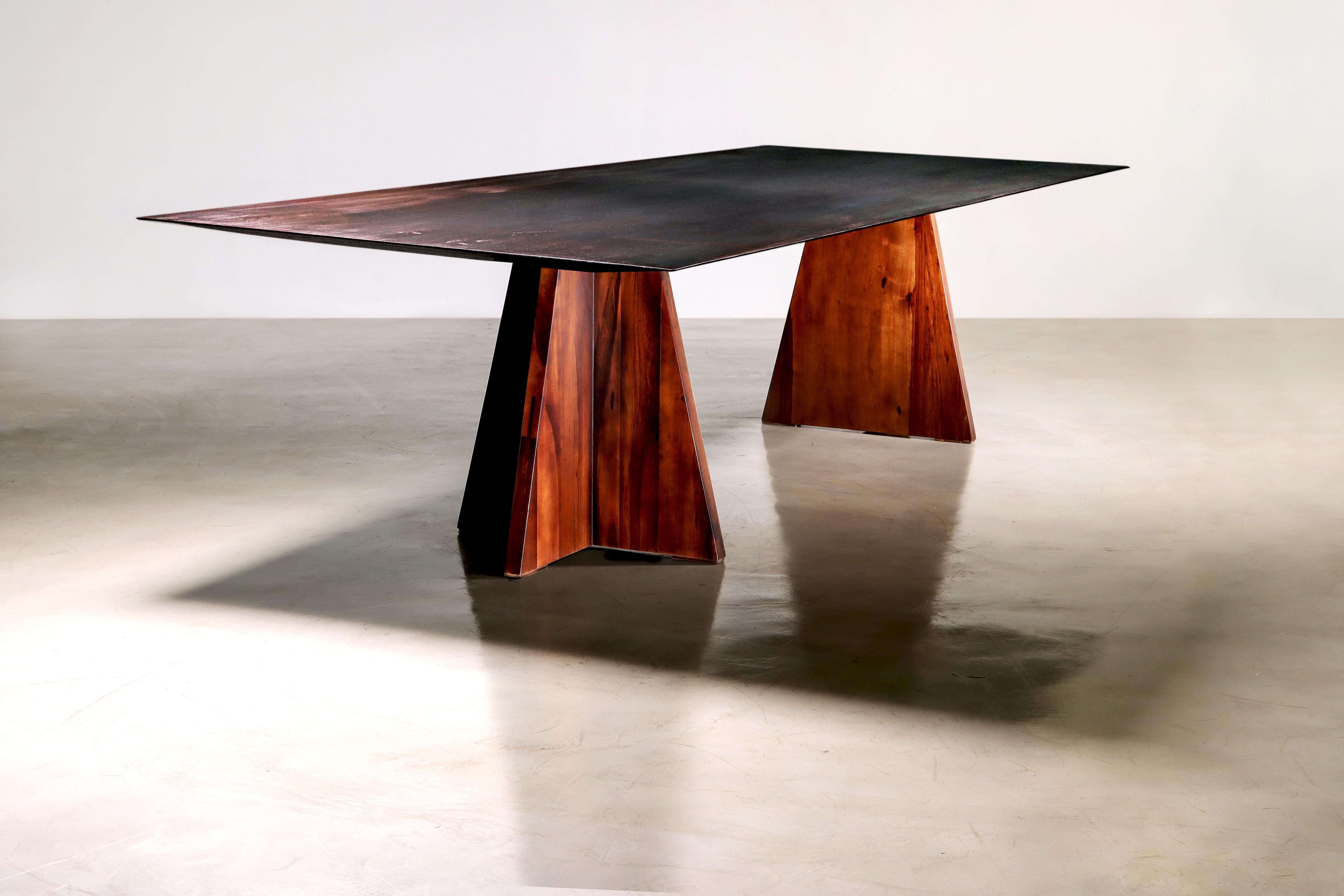 This one of a kind table is inspired by the massive sculptures of cold rolled steel by Richard Serra. The raw iron top was allowed to oxidize for several years before we applied a wax coating to lock in the textures. 

Available now as shown for