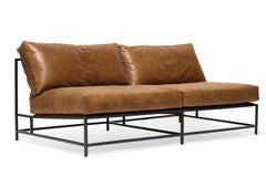 Poltrona in pelle di noce cerata e acciaio annerito