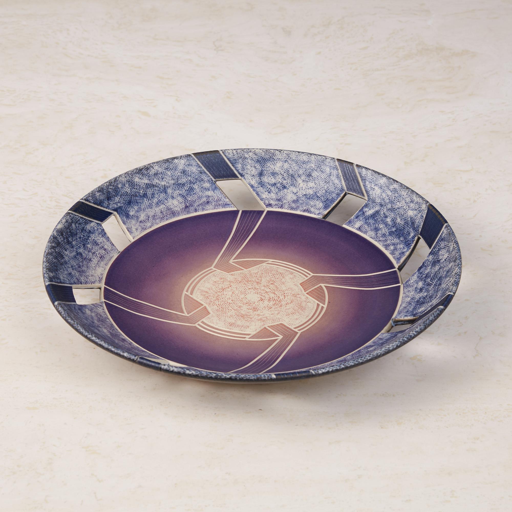 The practice of sgraffito is on full display on this plate made by ceramic artist Wayne L Bates. After spending decades teaching at various arts institutions, Bates became inspired by Native American artistry and studied their ceramics techniques.