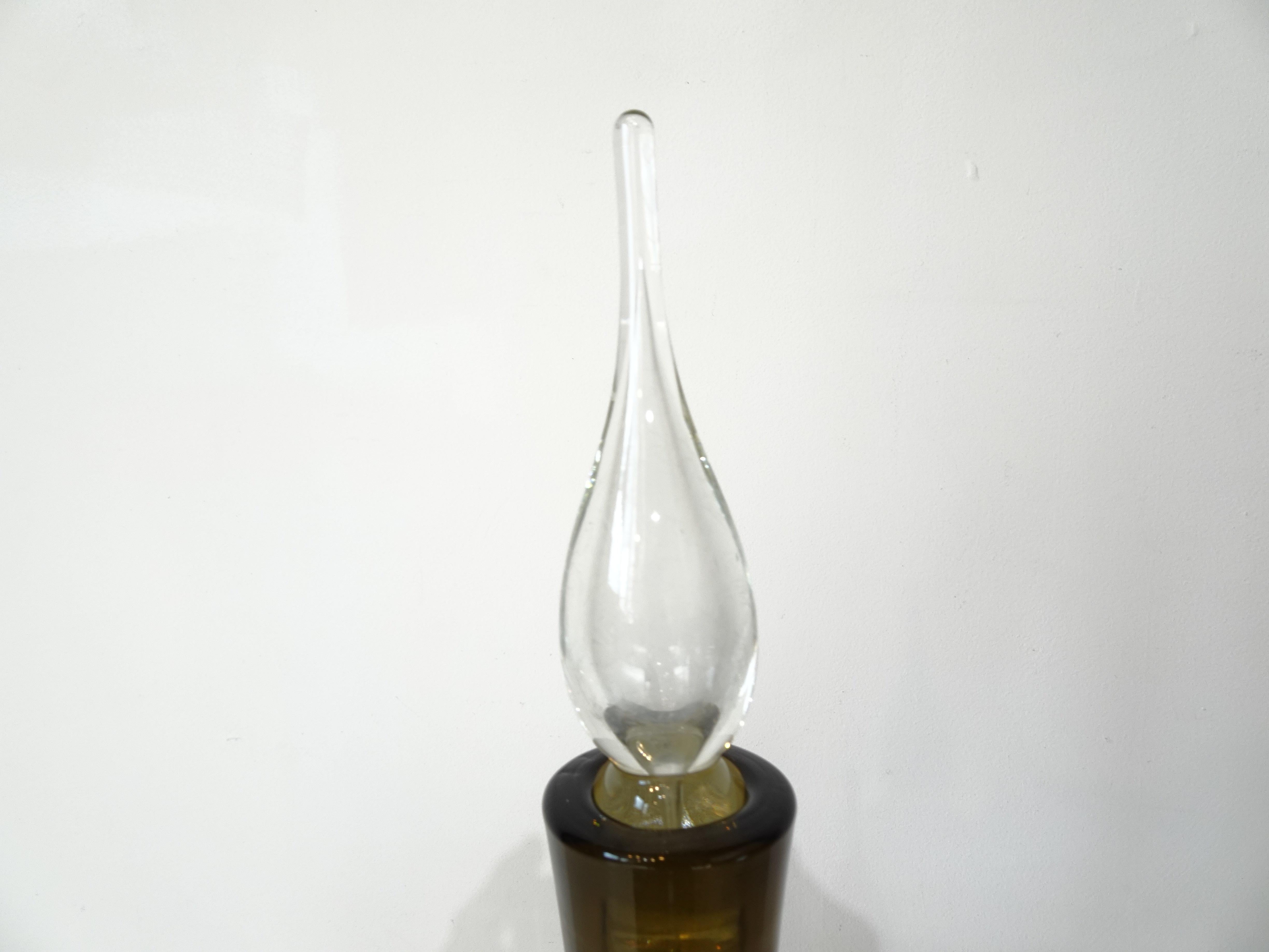 A handblown footed decanter vase in a smoked taupe color having the original flame stopper with a frost type finish to the inside executed in the Mid Century  . Crafted in the United States for the Bischoff Glass company who's pieces were a staple