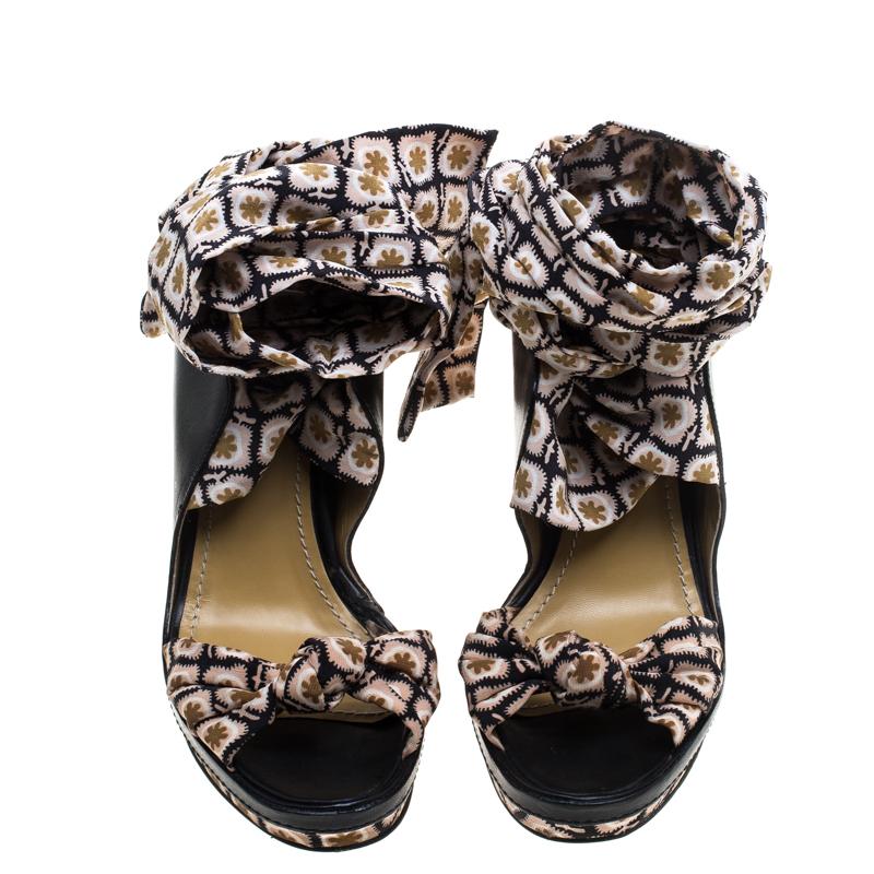 We adore this pair of sandals from Etro as it brings a smooth mix of simplicity and style. Set on platforms and wedge heels, the sandals feature printed satin straps on the vamps and as tie-ups with leather trims around the ankles. They are easy to