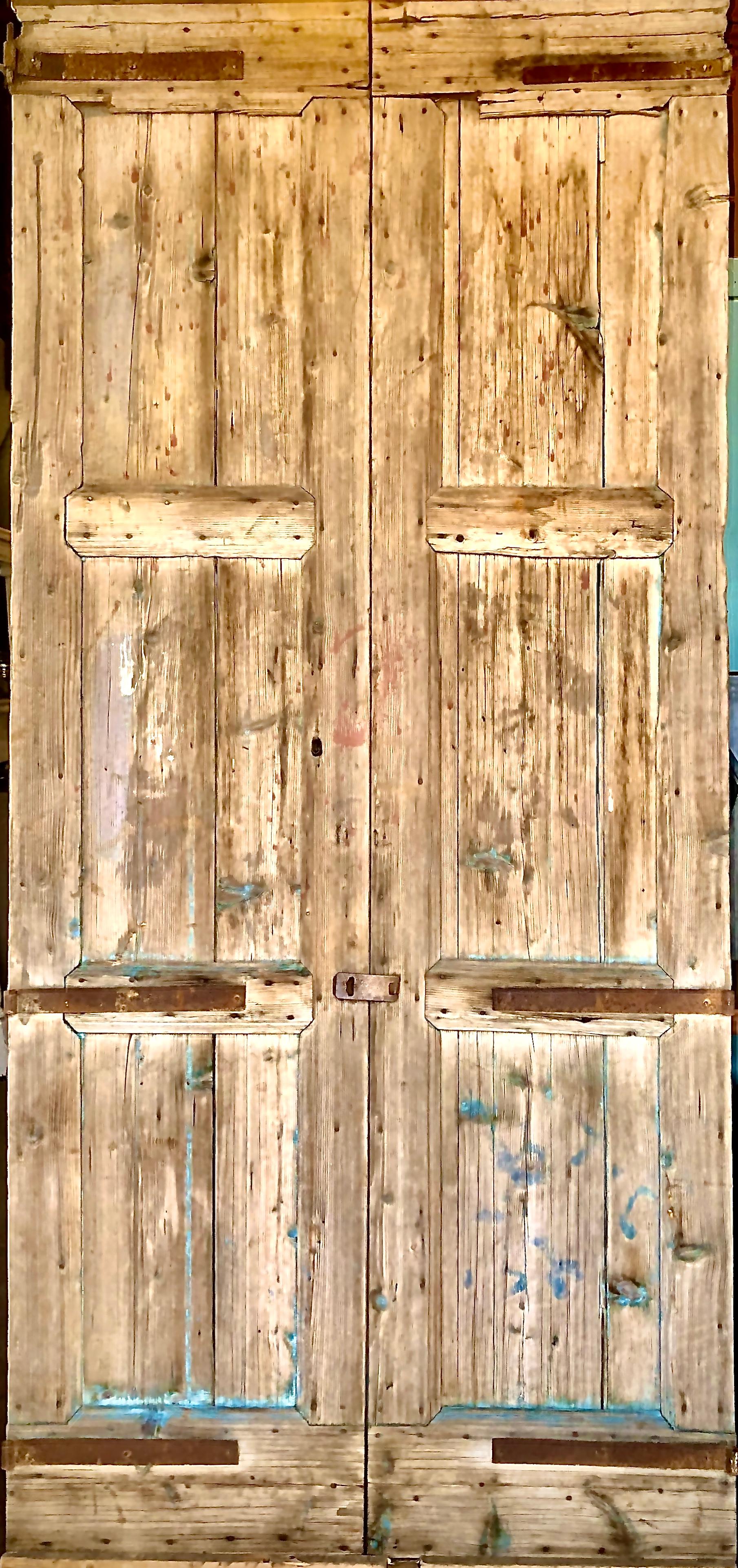 Beautifully aged and weathered barn doors with wrought iron hinges. Slight hints of blue paint that has long since surrendered to countless winter’s and summer’s.
 