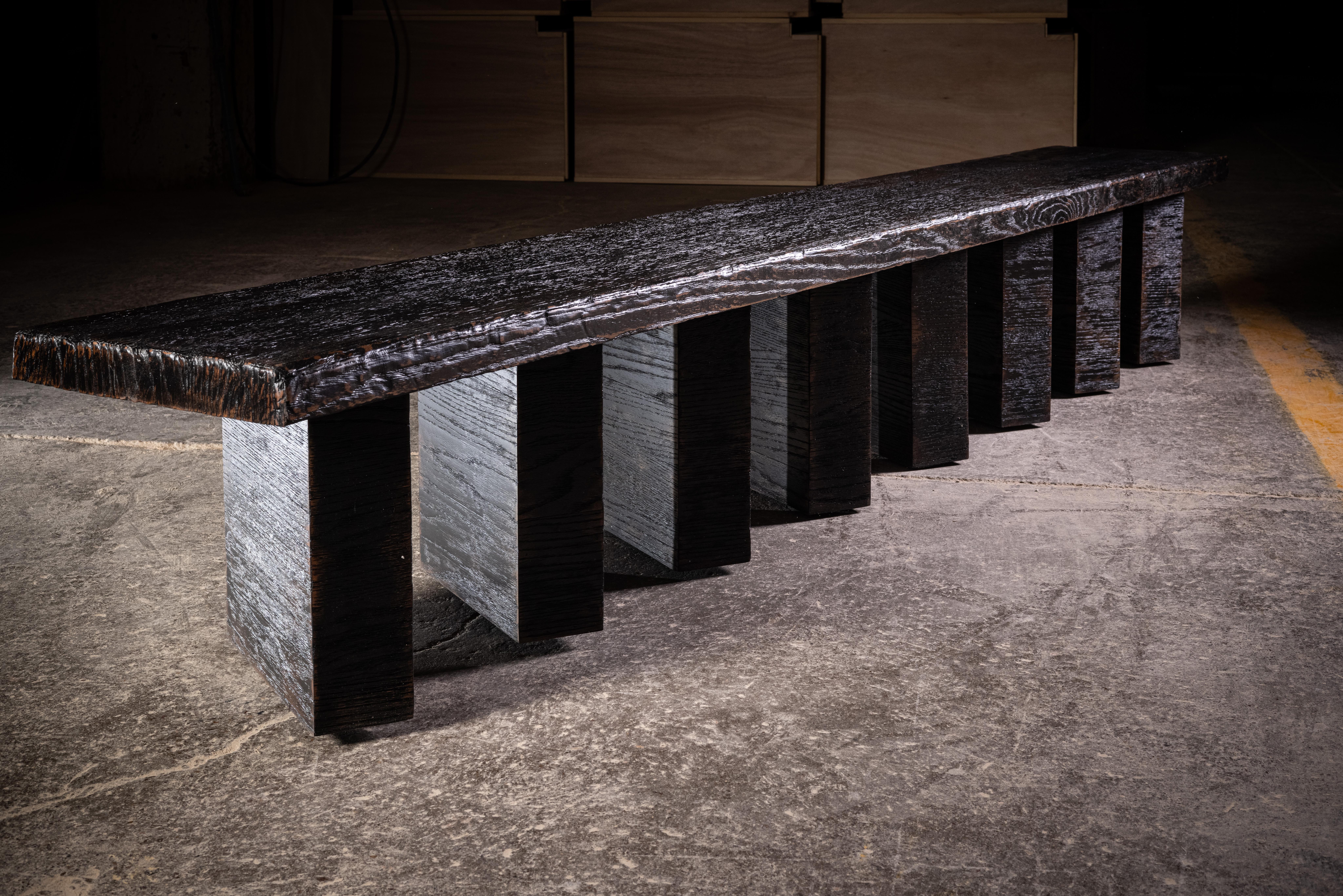 Weathered black oak handcrafted bench.