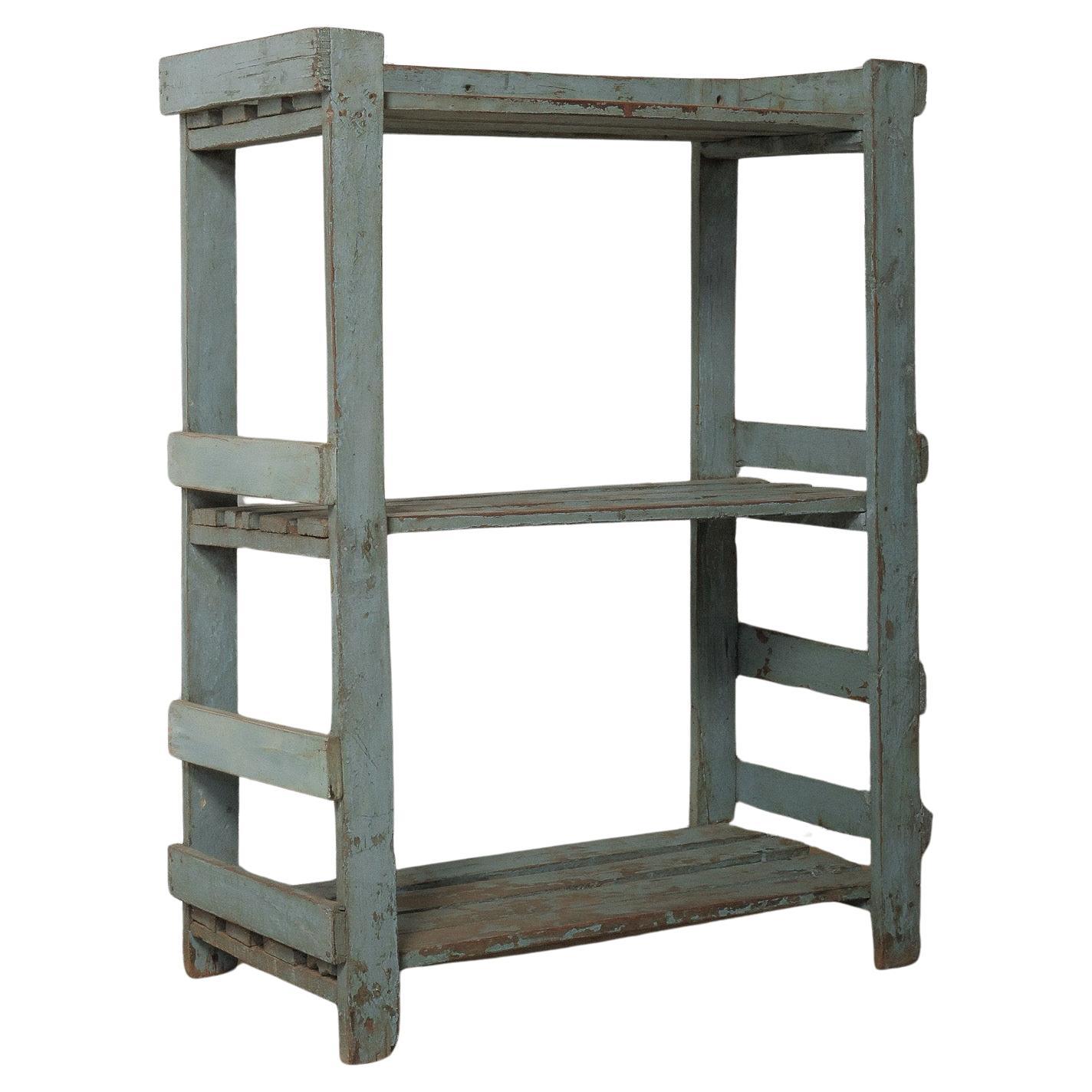 Weathered Blue Wooden Shelf with Open Framework