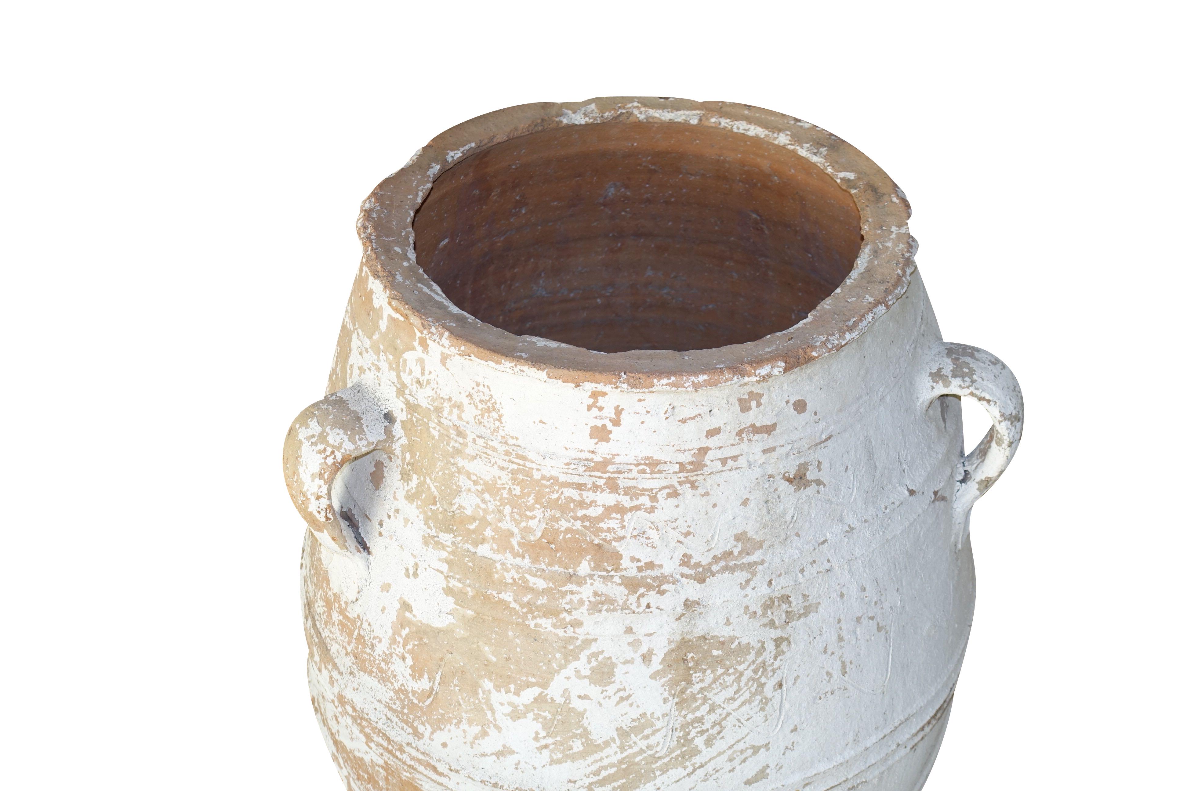 1920s large Greek olive jug with original painted patina.
There are three large handles and decorative horizontal ribbed detailing.
The terra cotta jug was originally used to store olives.
Top opening is 13
