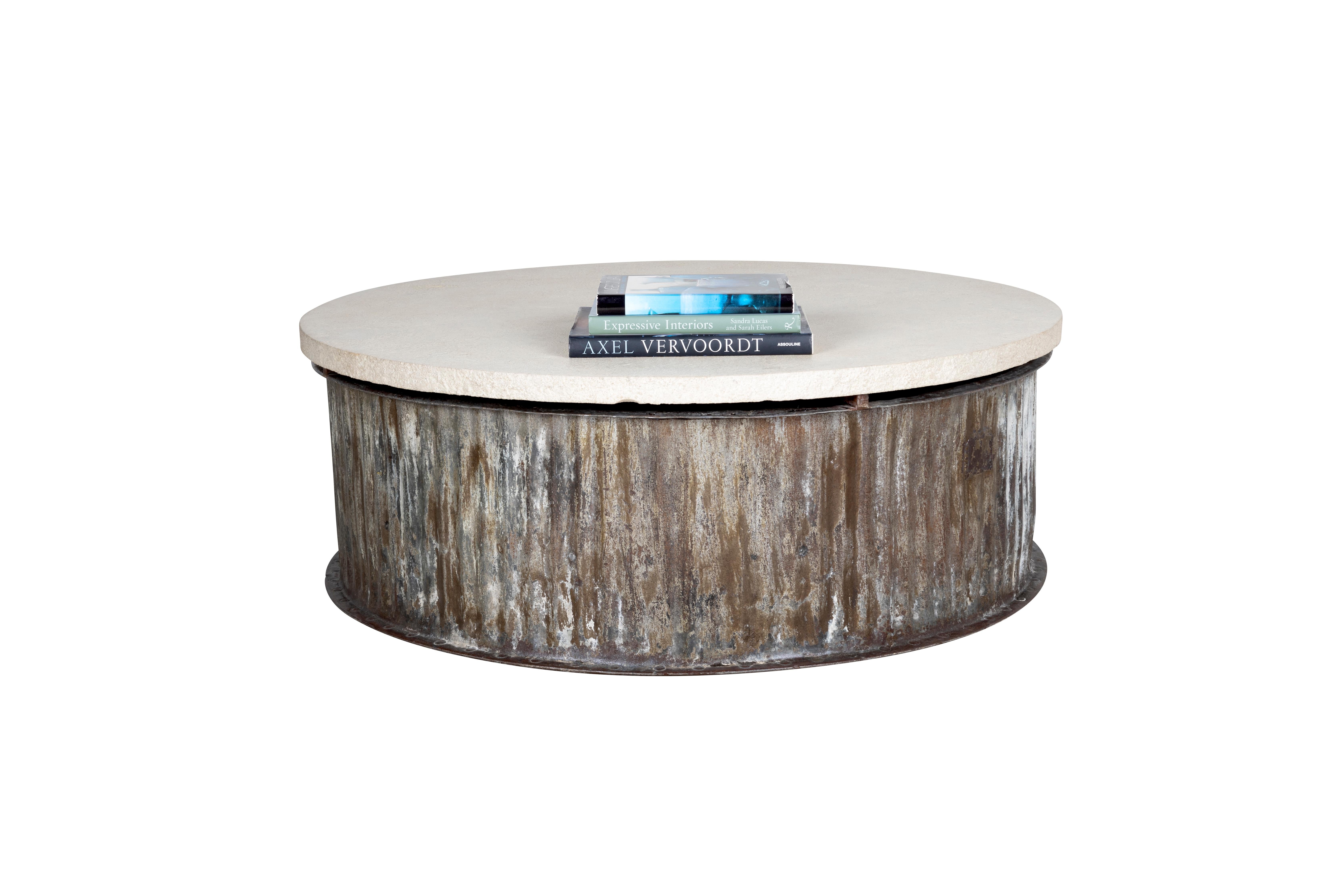 Create a classic, refined look with our weathered metal base bearing a Lueders limestone top coffee table. Our Weathered Metal Base Coffee Table brings a striking design to your living room. A weathered metal base complements the unique gray tone of