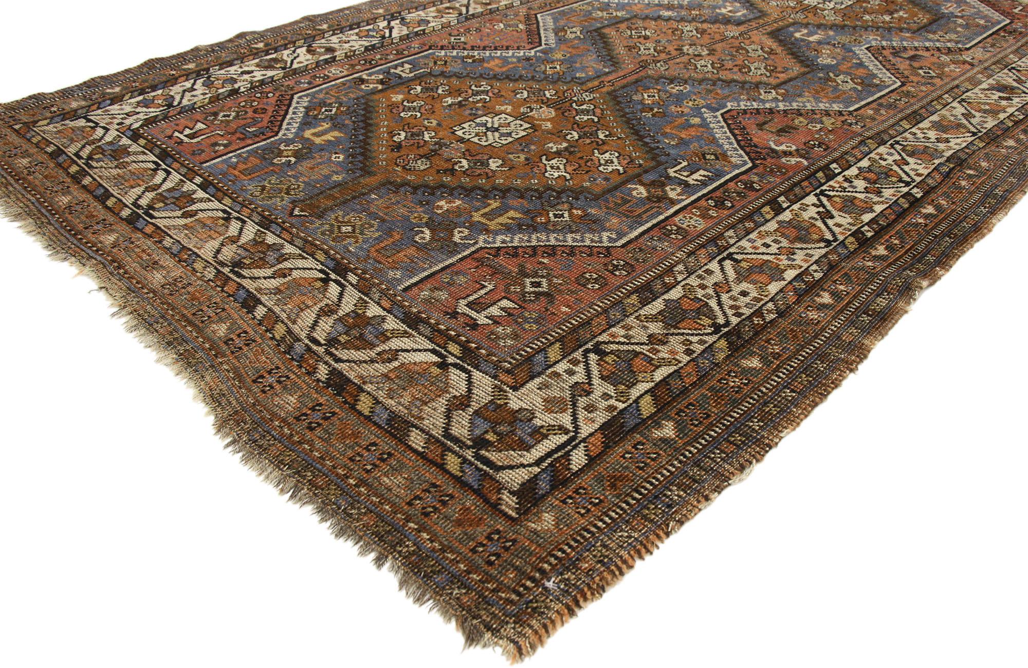 73298 Distressed Vintage Persian Shiraz Rug with Tribal Style 04'06 X 06'10.
Warm and inviting with rustic sensibility, this hand-knotted wool vintage Persian Shiraz rug beautifully embodies tribal style with nomadic charm. The weathered field