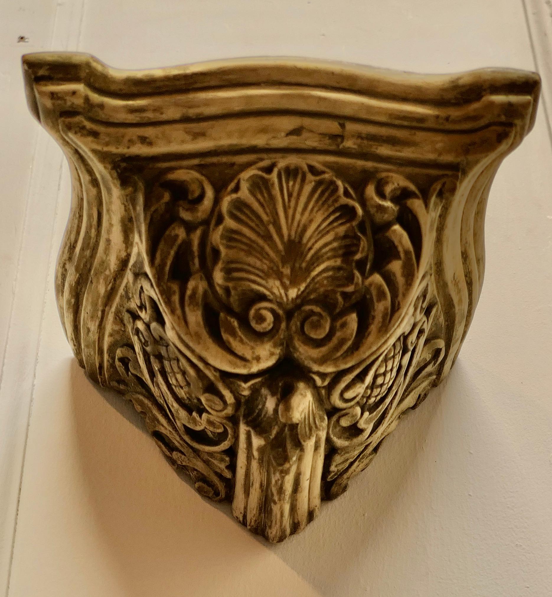 Weathered Wall Bracket, carved with Shell Decoration

This is a well weathered piece, the bracket is made in hard plaster with a very worn gilt finish
It is in generally good condition with a weathered finish 
The bracket is 6” high, 10” x 9 ” on