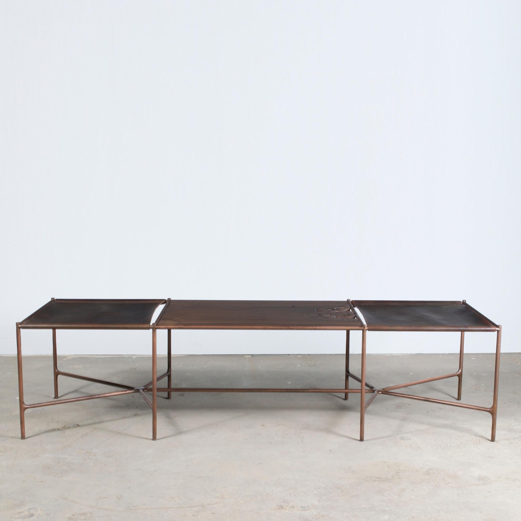 Oiled cast bronze, saddle tanned leather, and organic oxidized walnut. 

Designed by master craftsman Jacob Wener, through his company Modern Industry Design, this bench is one of the first iterations of his Web Series. The cast bronze base serves