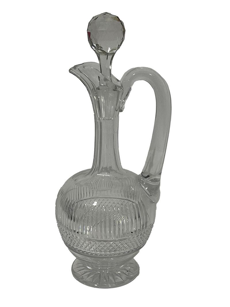 Webb Corbett Crystal Cut Glass and Decanter Set, 1960s

A set of two decanters, a jug, and glasses with vertical and cross-shaped crystal cuts. The 10 crystal glasses have an etched mark beneath the feet, the rest are unmarked.

A 25 cm high ship's