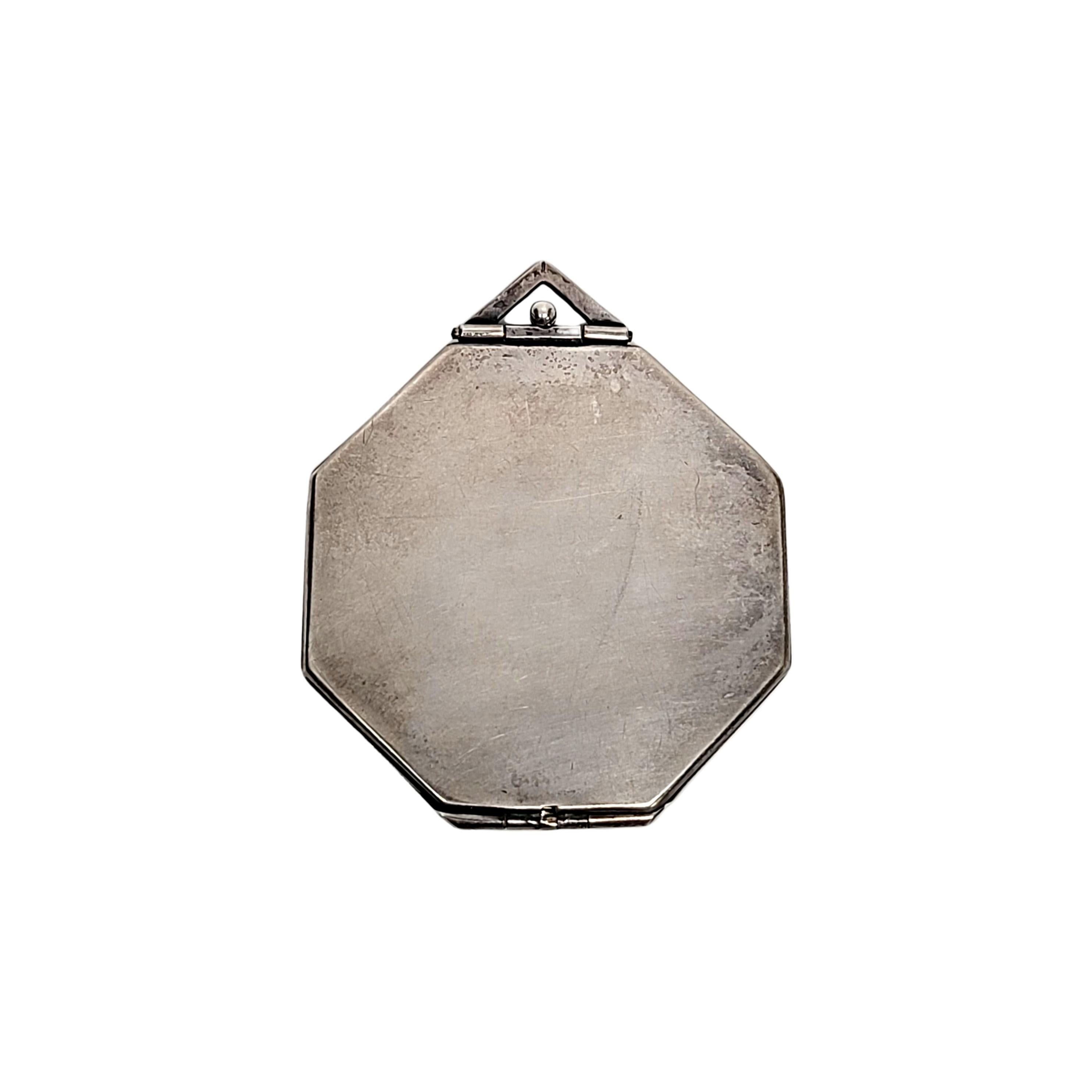 Octagon sterling silver locket pendant by Webster Co.

This beautiful sterling silver oval locket features a hammered finish with a smaller octagon cartouche at the center on the front, and a polished smooth back. Hinged bottom, opens from the