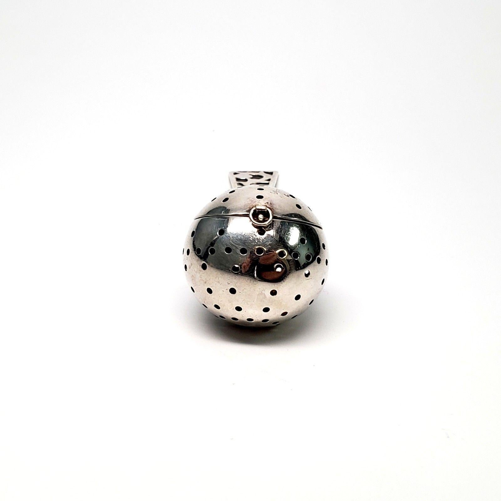 Webster sterling silver ball tea infuser/strainer with cut-out design handle. Marked: Sterling, Webster hallmark. Measures 5