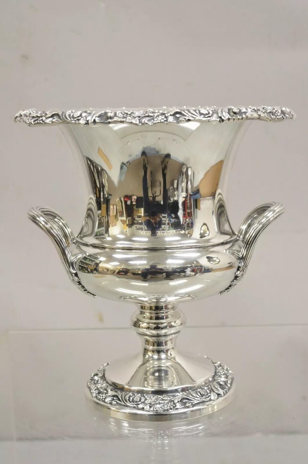 Webster Wilcox International Silver Co Silver Plate Trophy Cup Champagne Chiller. Item features ornate floral repousse base and rim original hallmark. Very nice vintage bucket. Circa Mid 20th Century. Measurements: 11